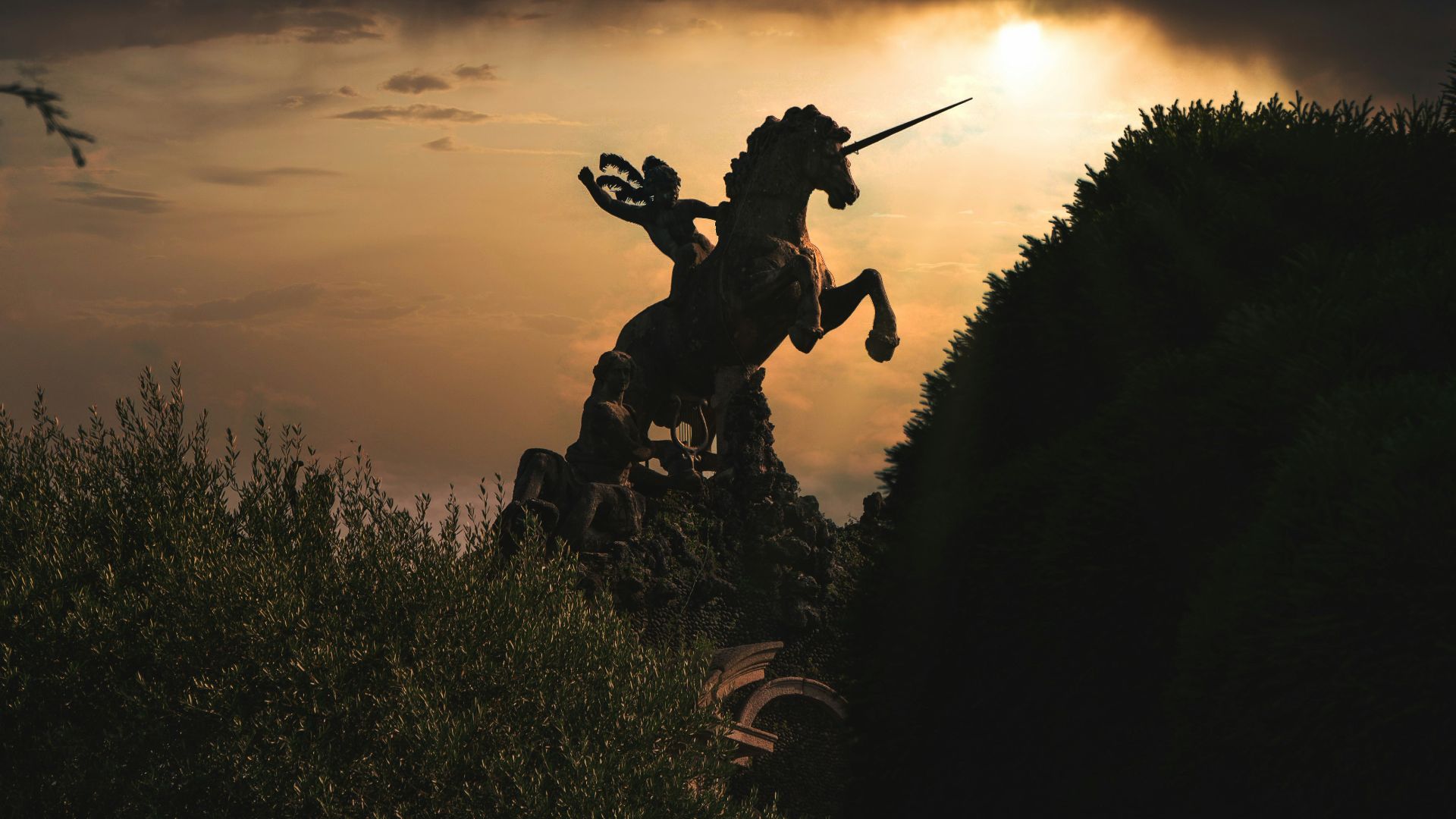 silhouette of man holding stick during sunset