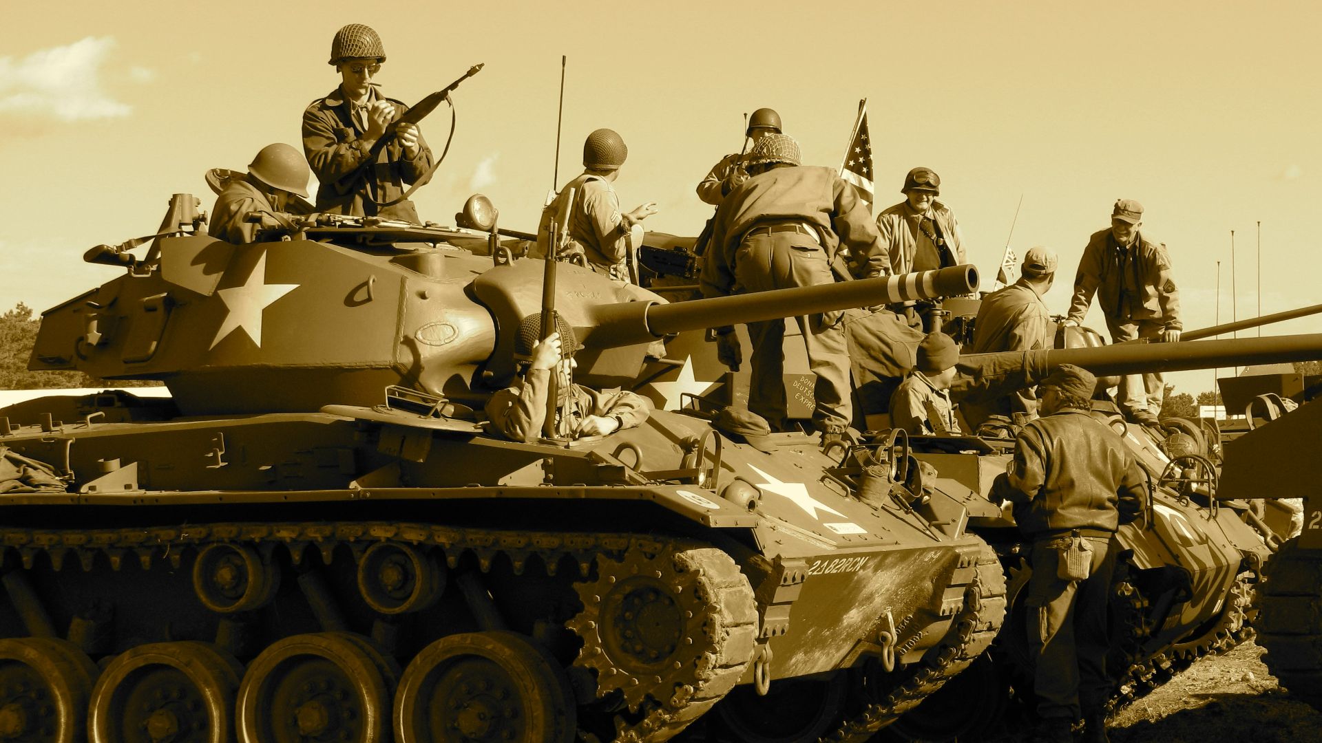 people sitting and standing on battle tank
