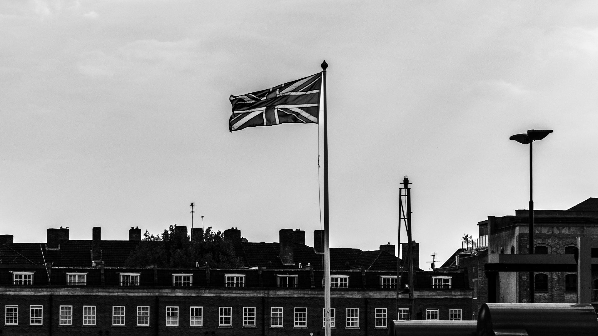 a black and white photo of a flag flying in the wind