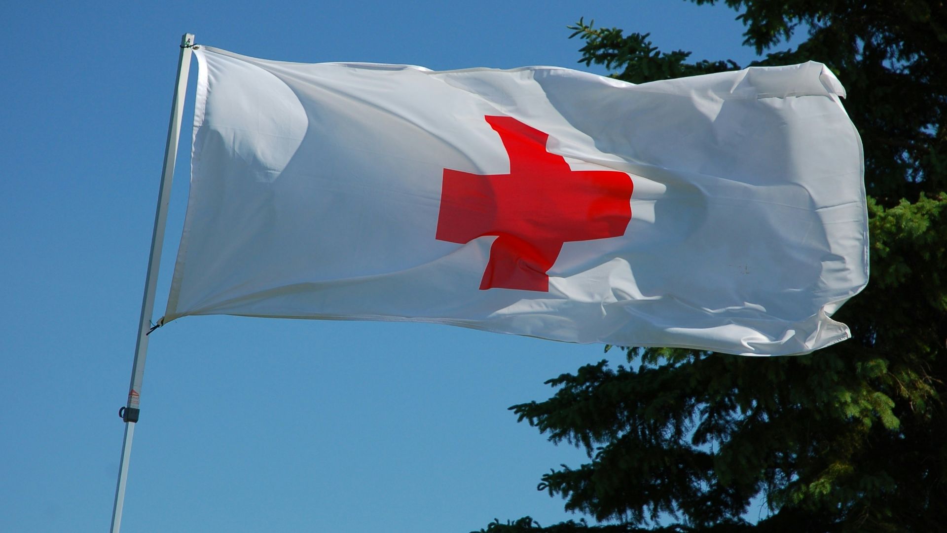 white and red flag on pole