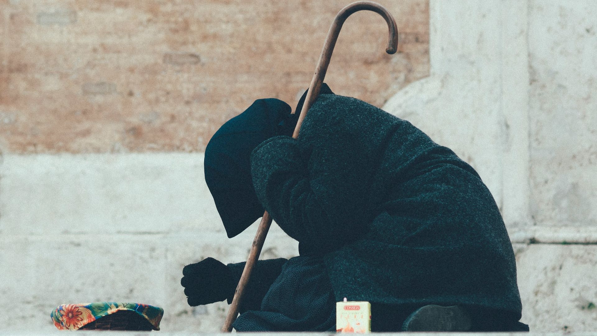 person in black jacket sitting on floor