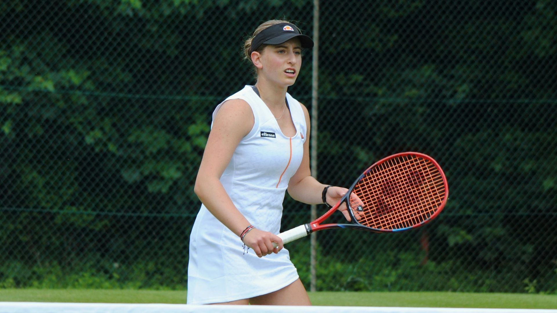 A woman holding a tennis racquet on a tennis court