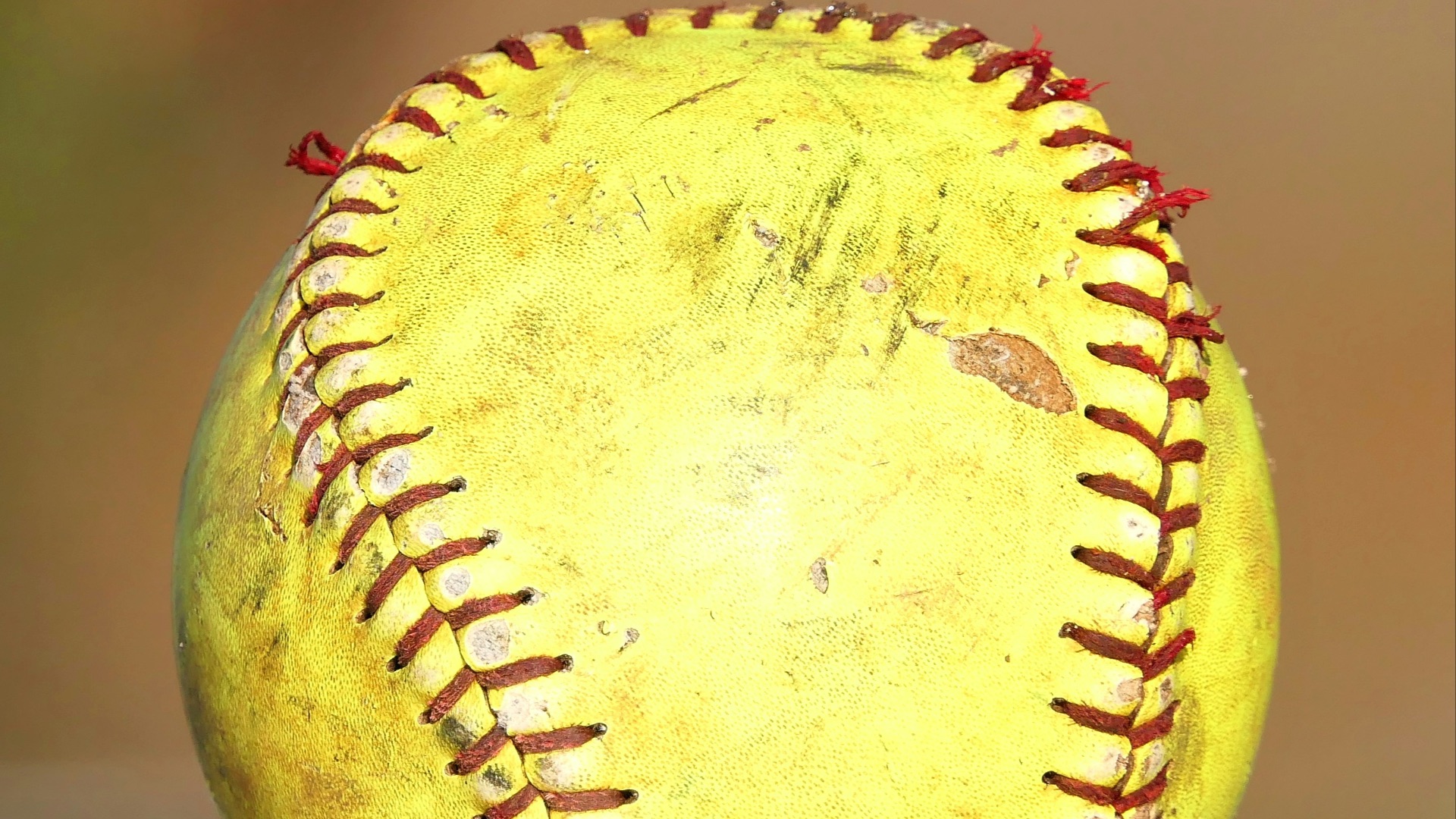 a yellow baseball sitting on top of a table