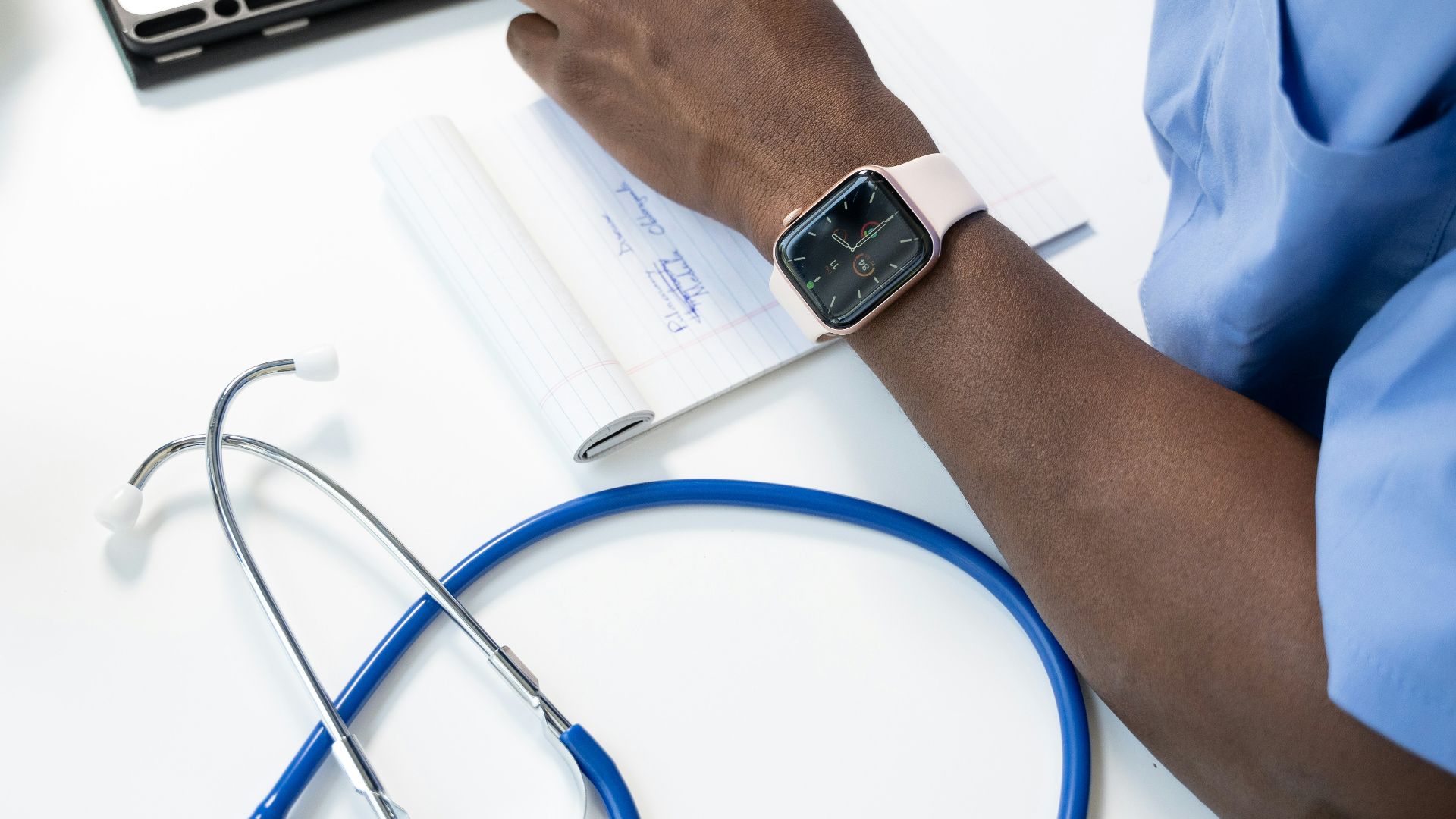 a person's hand on a piece of paper with a watch on it
