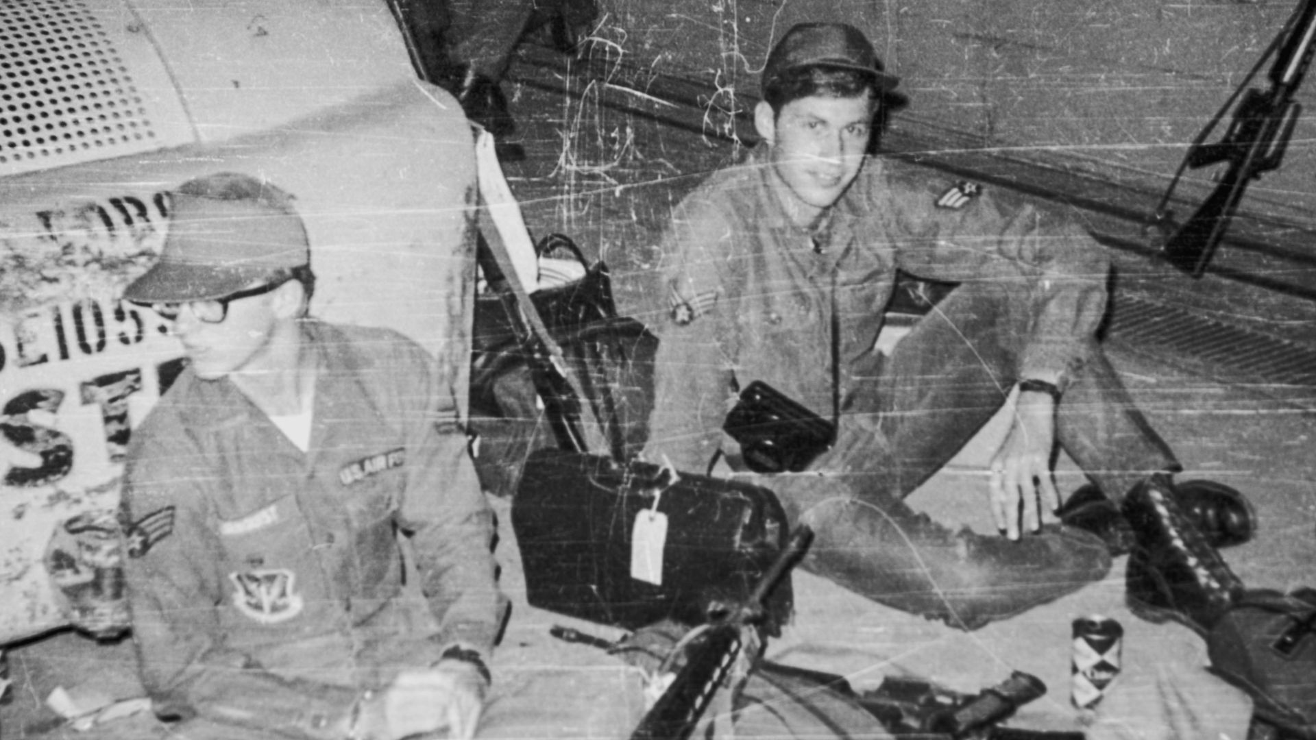a group of men sitting next to each other in front of a plane