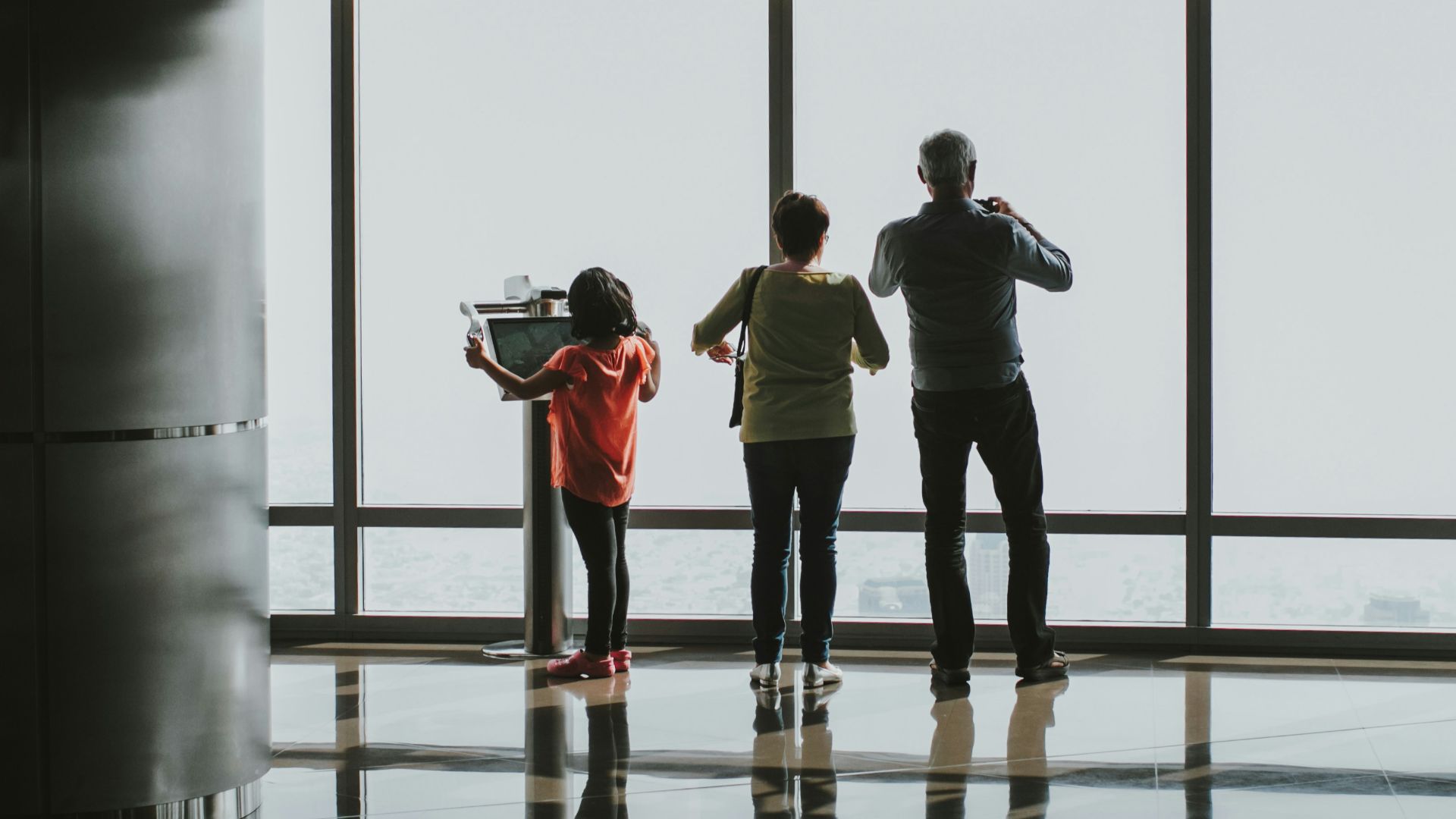 a group of people standing in front of a window