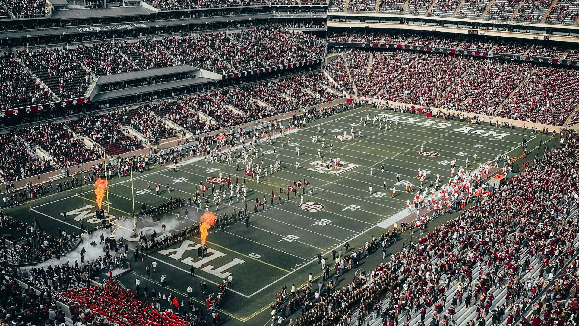 people watching soccer game during daytime