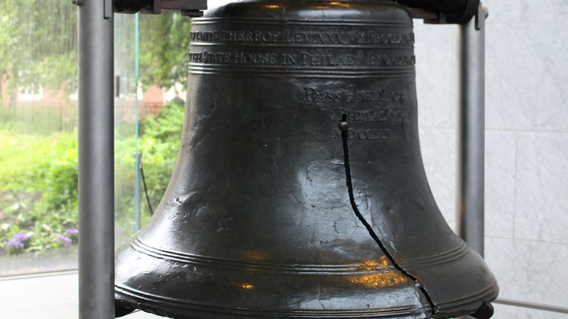 A large metal bell sitting on top of a table