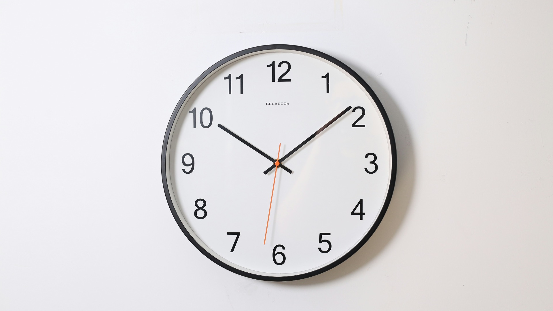 round analog wall clock pointing at 10:09