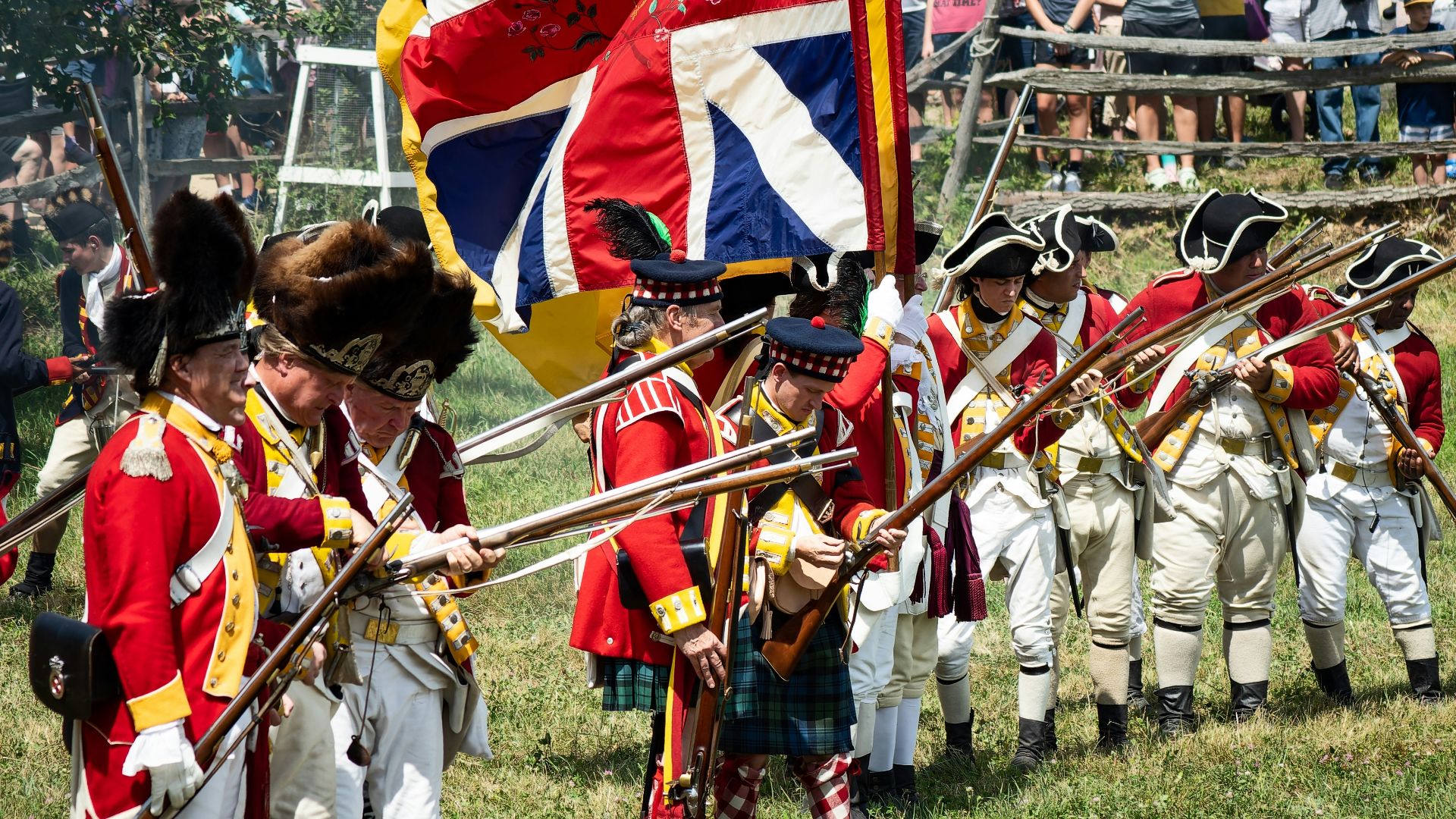 a group of people in uniform holding flags and a flag