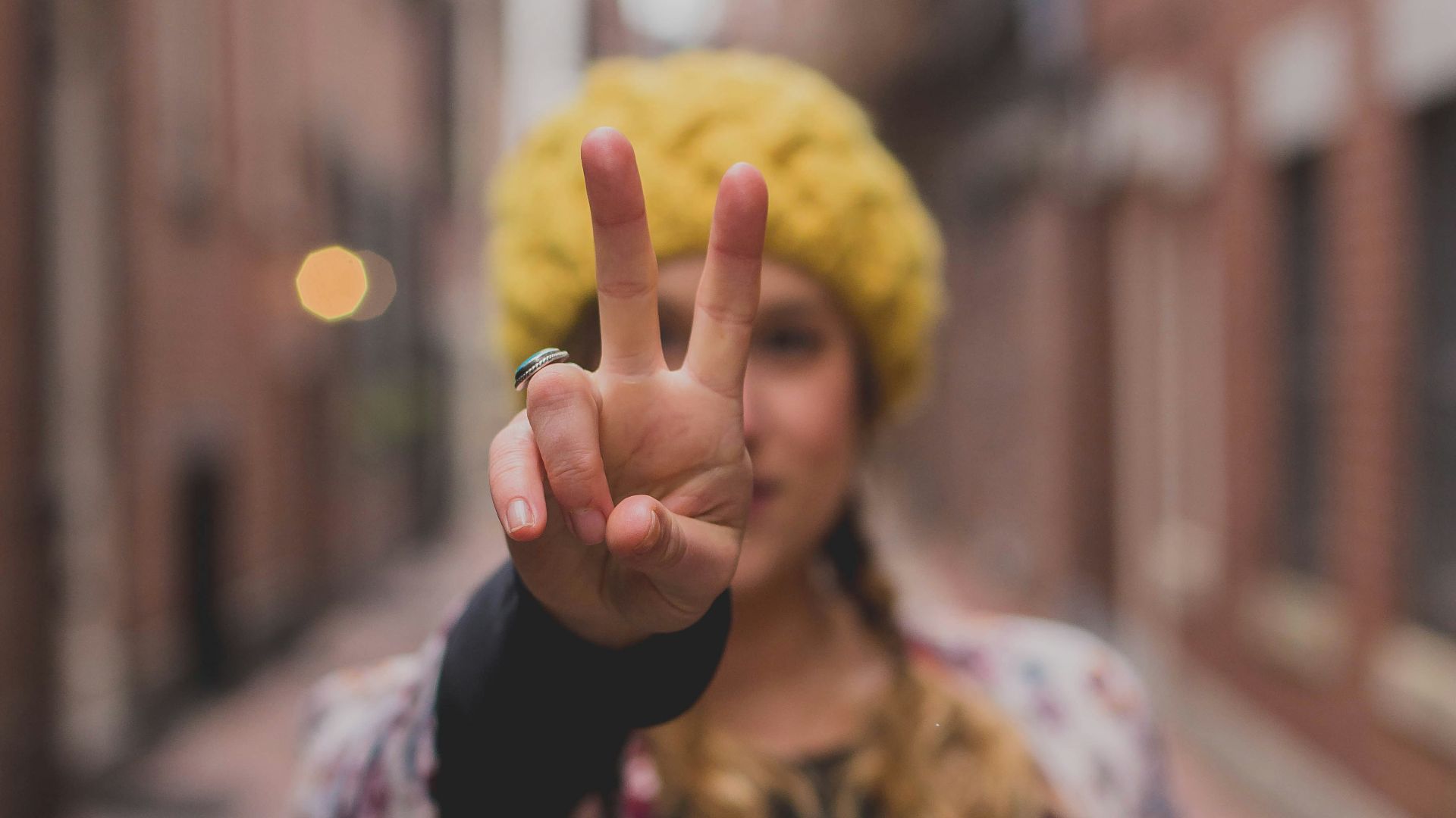 woman in black and white floral cardigan holding yellow ball