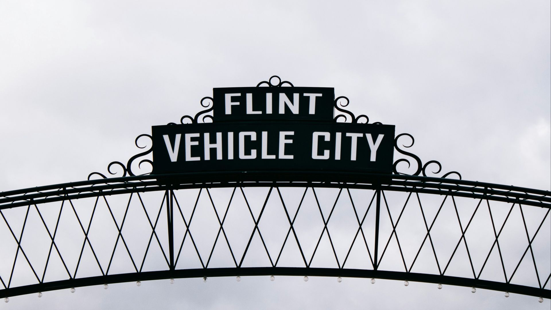 a black and white sign that reads flint vehicle city