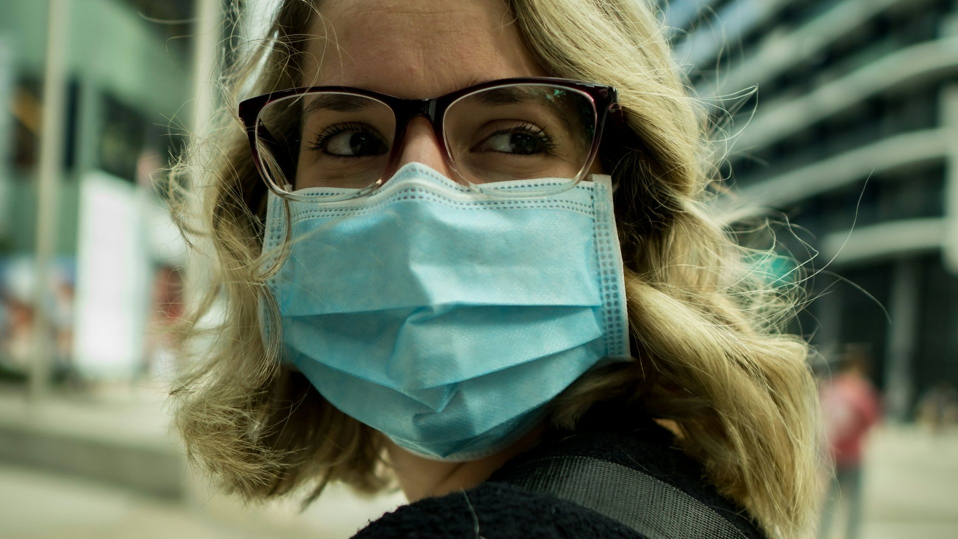 woman in black coat wearing eyeglasses