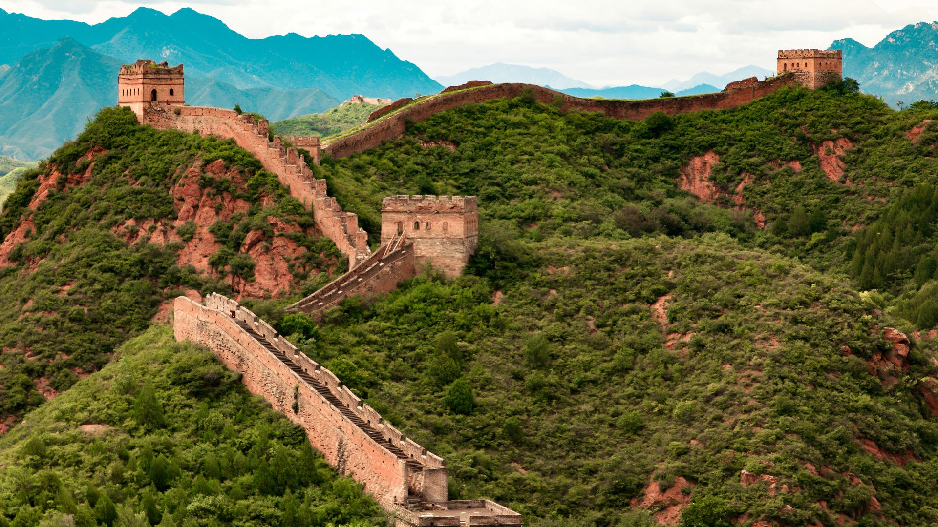 green trees on mountain under white clouds during daytime