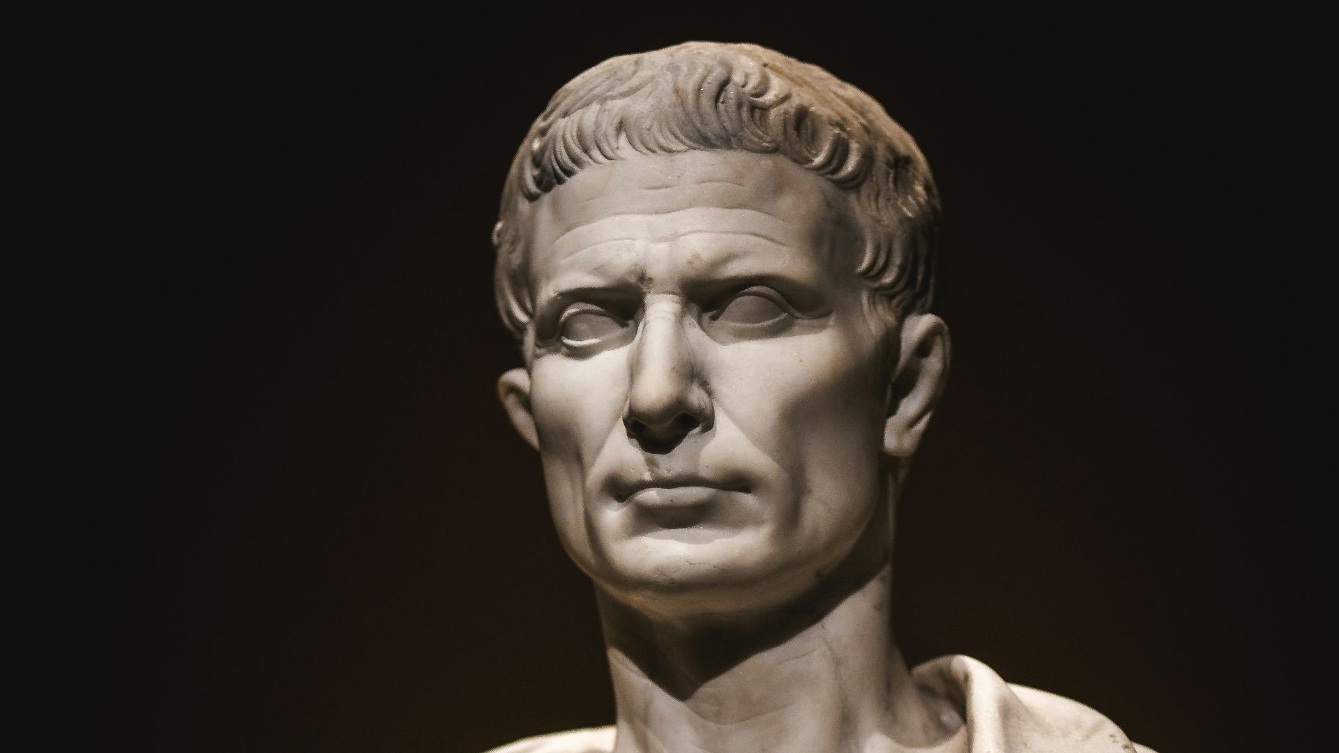 A bust of a man with a cape around his neck