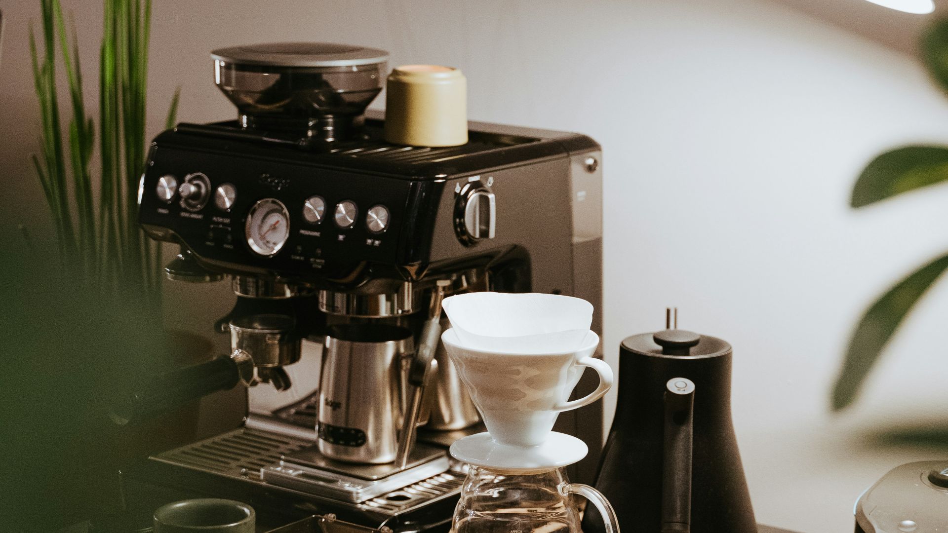 black and silver coffee maker on brown wooden table