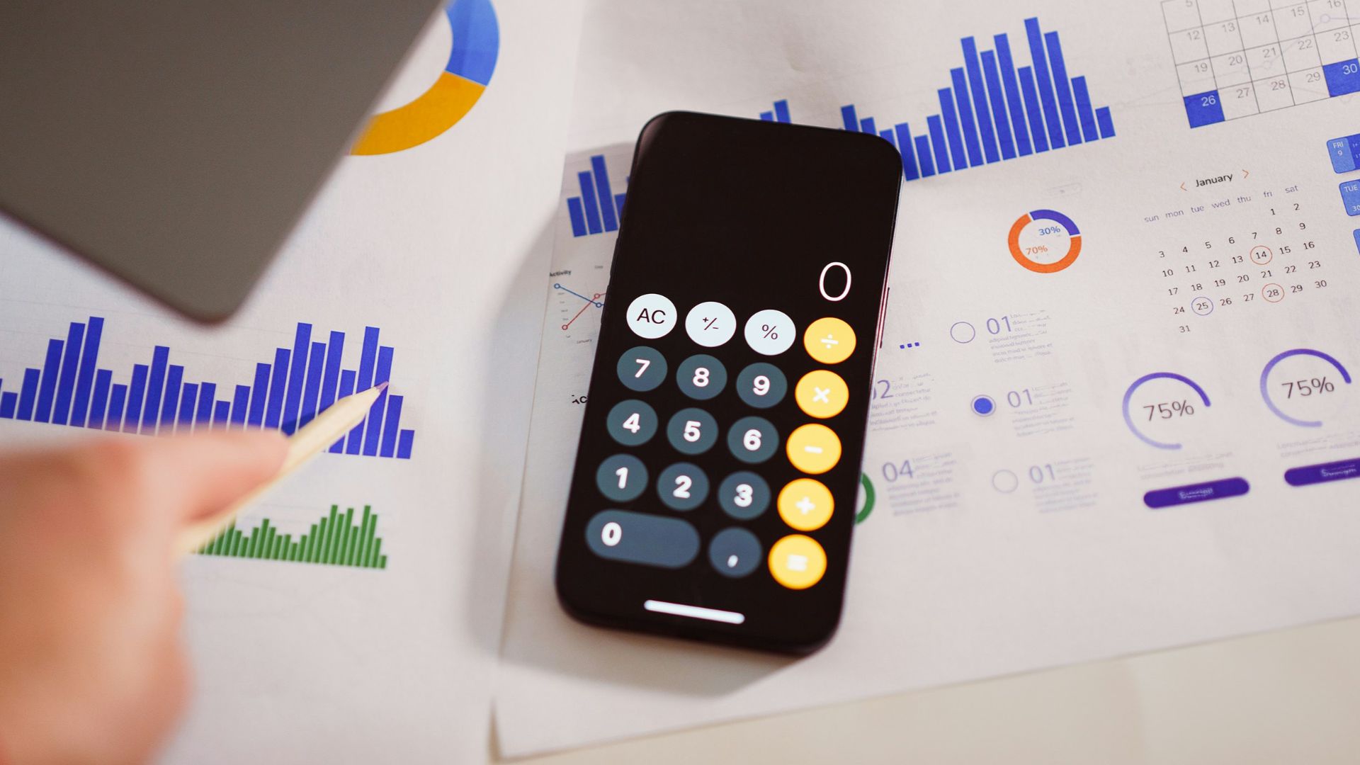a calculator sitting on top of a table next to a laptop
