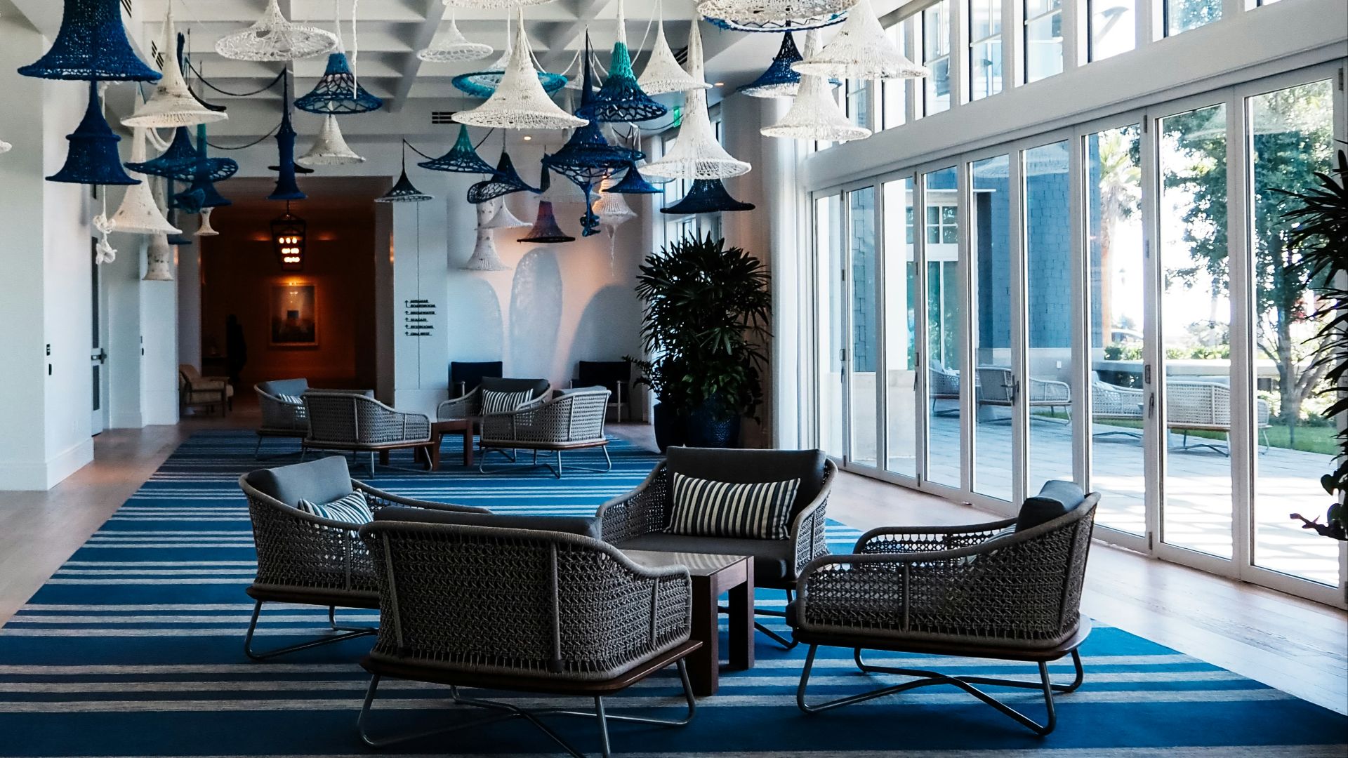 a large room with chairs and lamps hanging from the ceiling