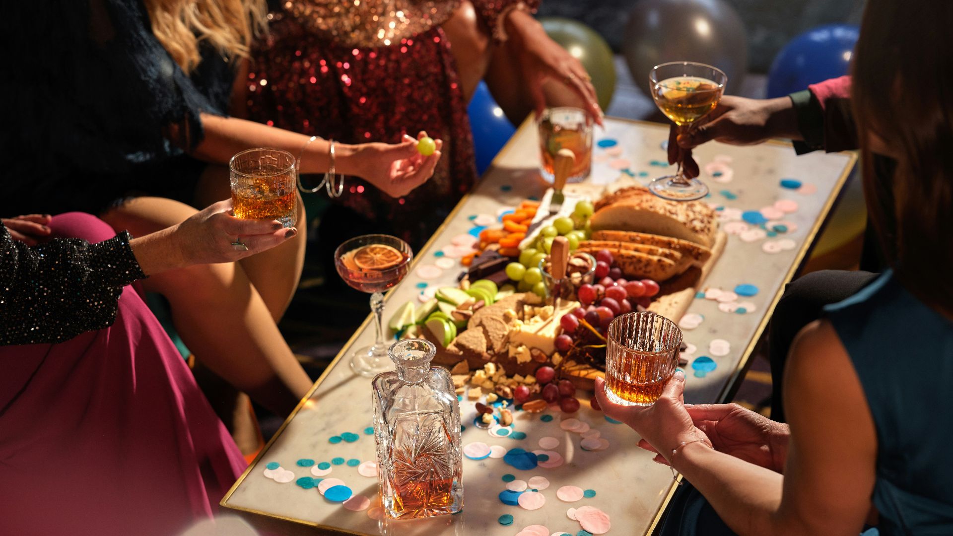a group of people sitting around a table with food and drinks