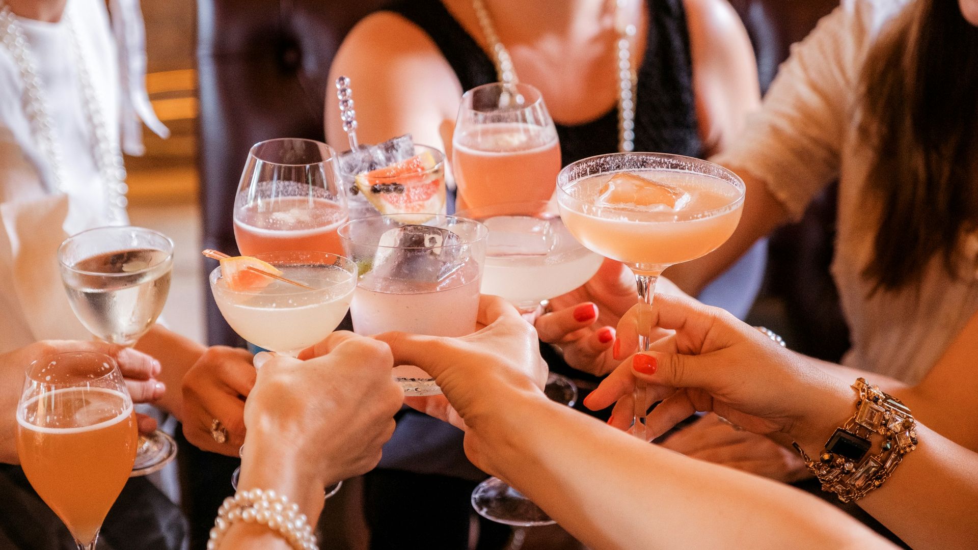 woman in black tank top holding clear wine glass