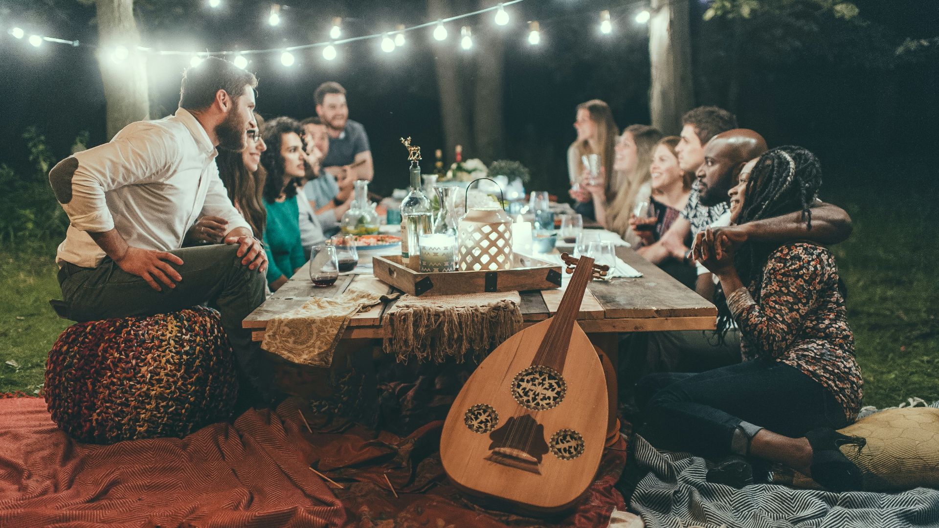 people sitting on chair in front of table with candles and candles