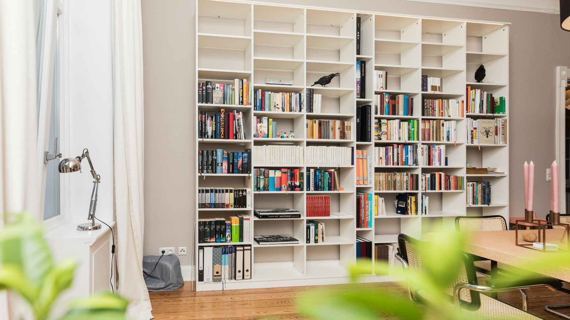 white wooden book shelves on brown wooden parquet floor