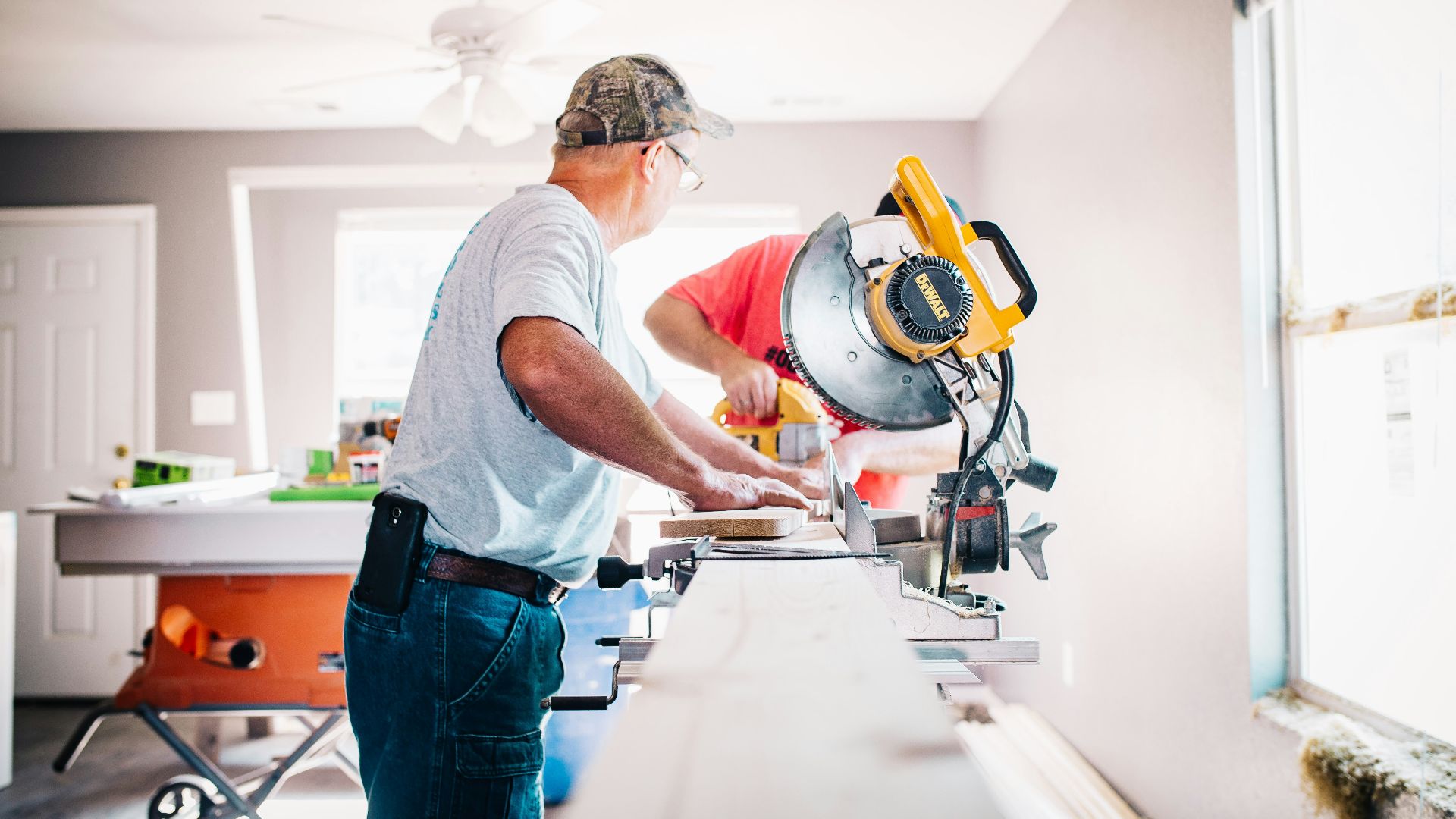 man standing infront of miter saw