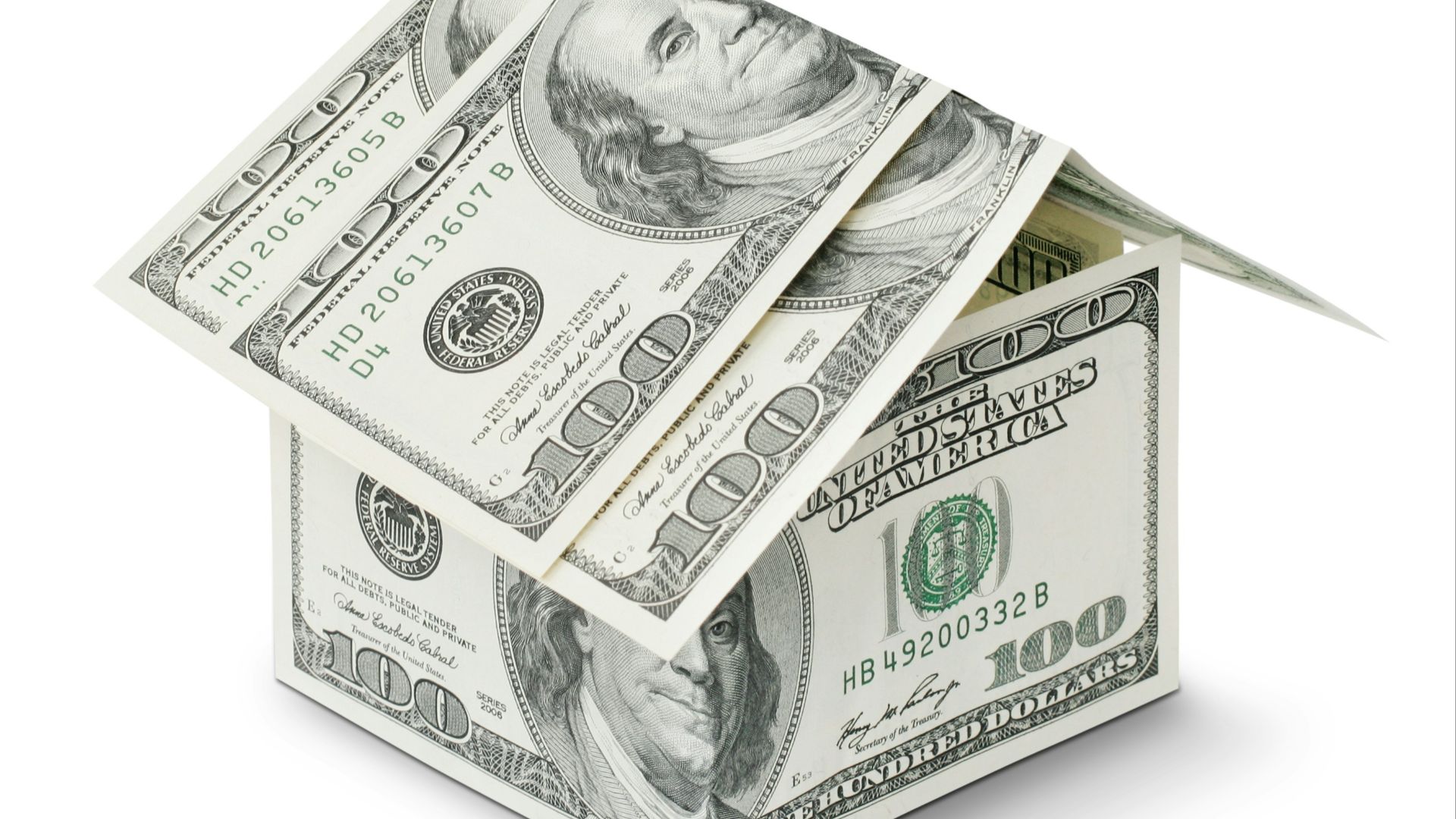 a house made out of money on a white background