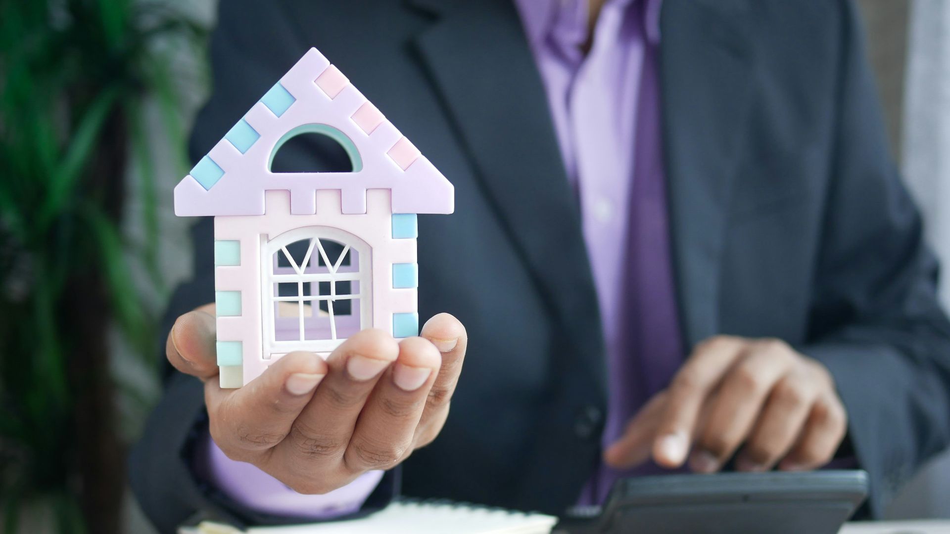 man in purple suit jacket using laptop computer
