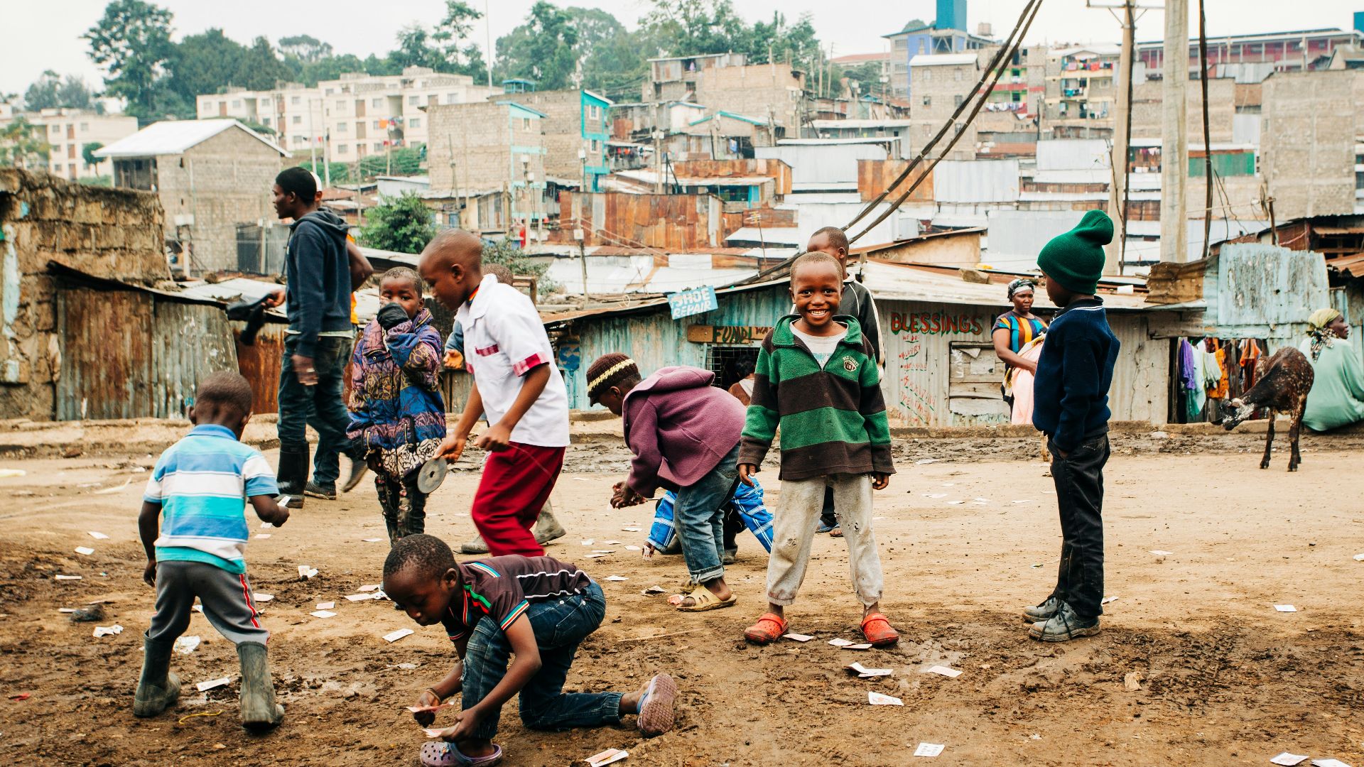 children playing on brown sand at daytime