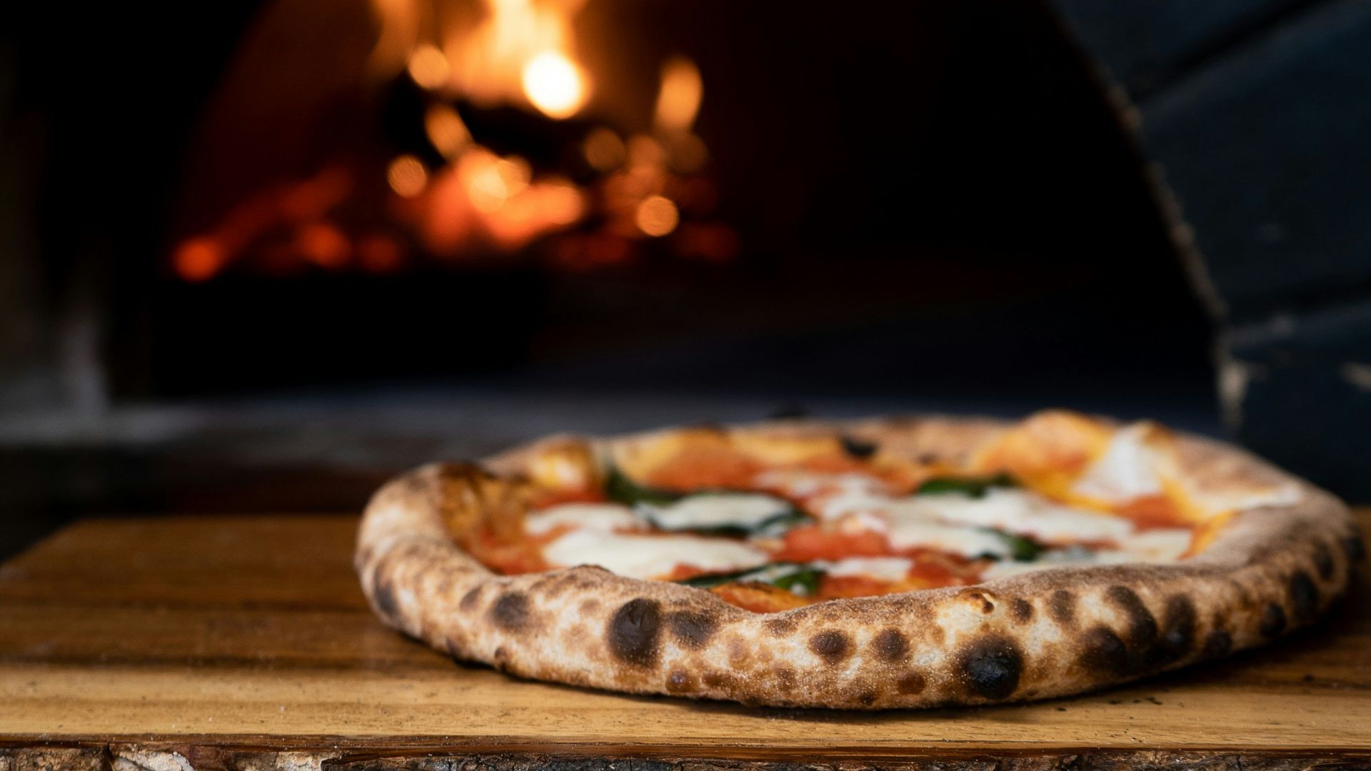 pizza on brown wooden table