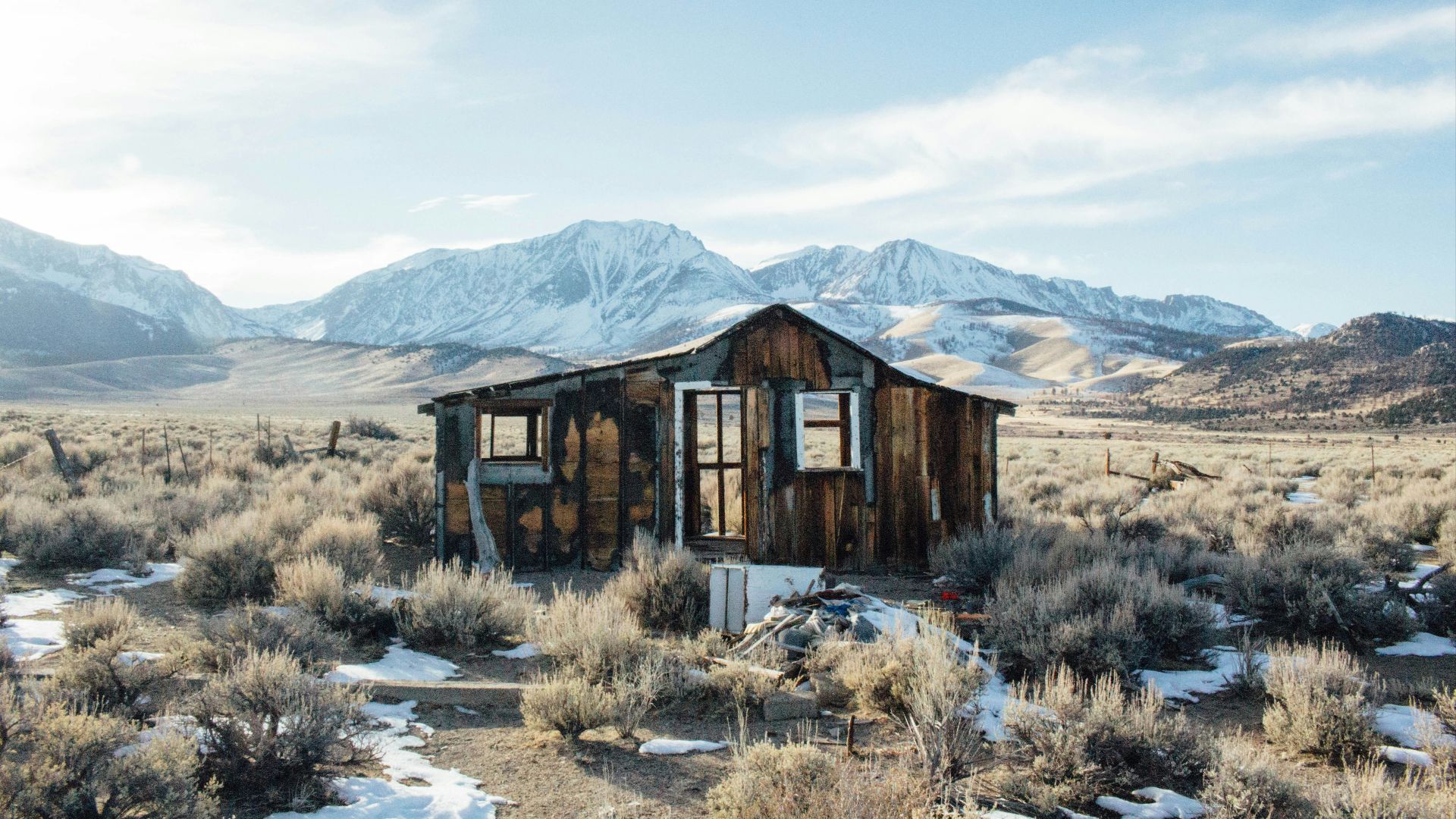 wrecked brown wooden house standing on brown grass field during daytime