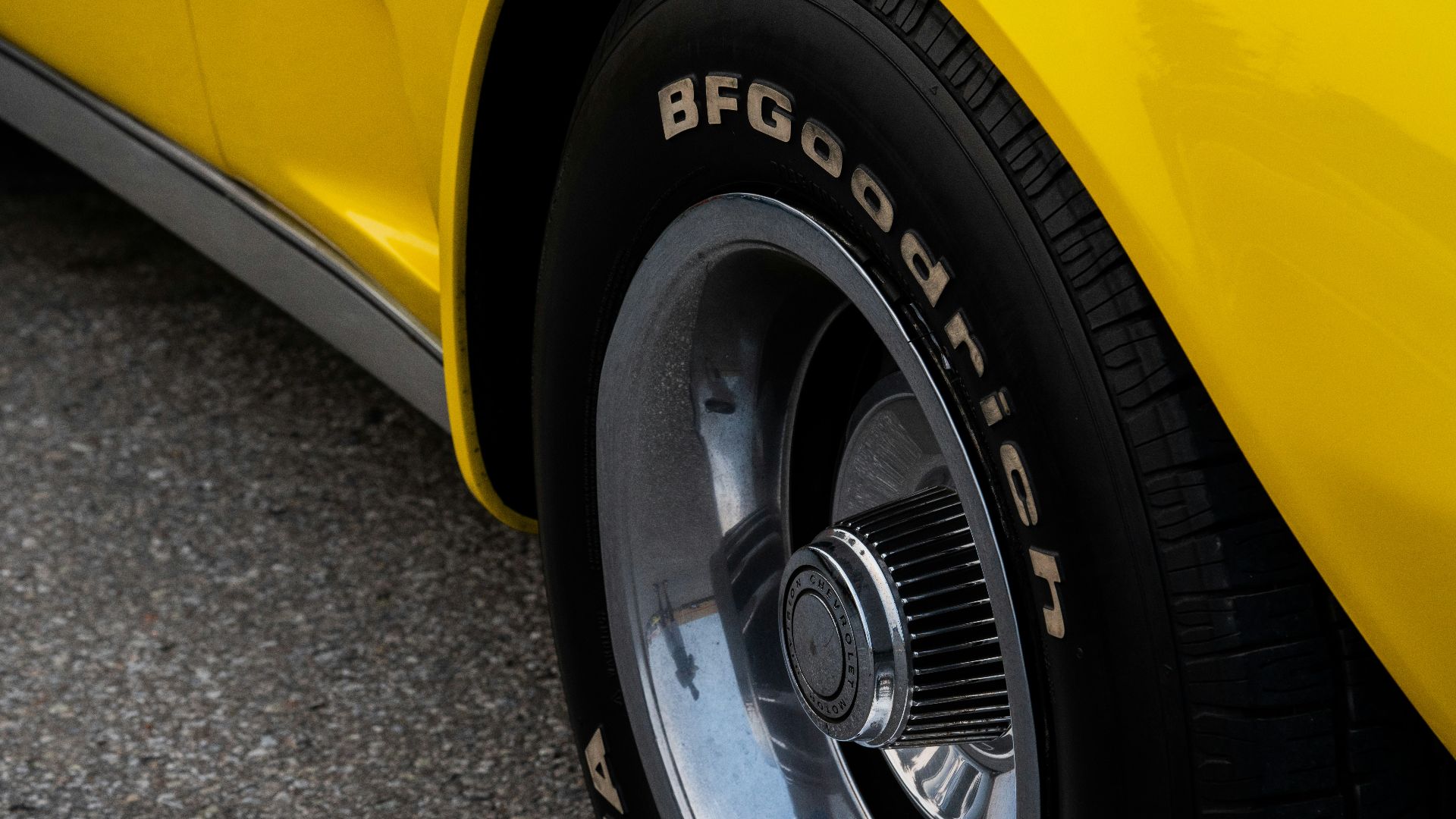 a close up of a yellow sports car tire