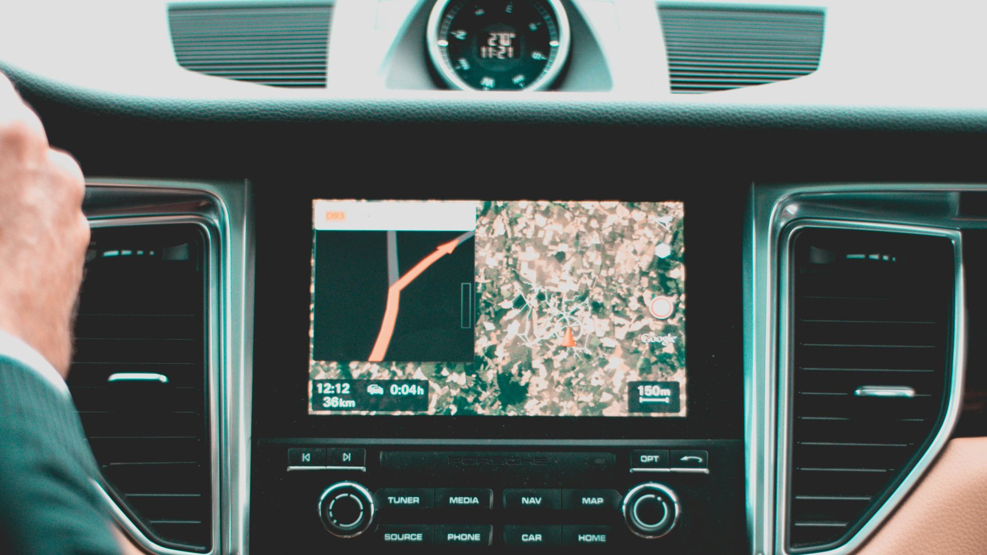 person holding steering wheel