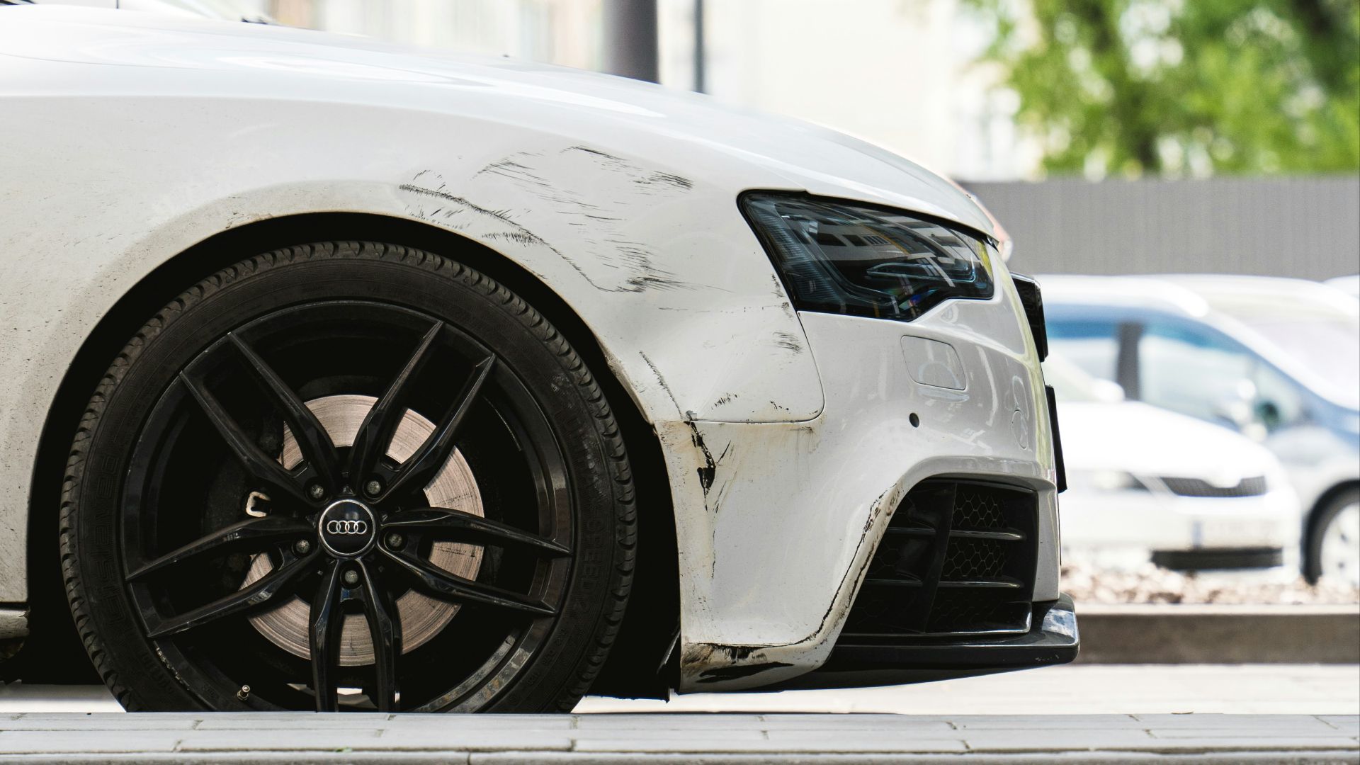 a white car parked on the side of the road