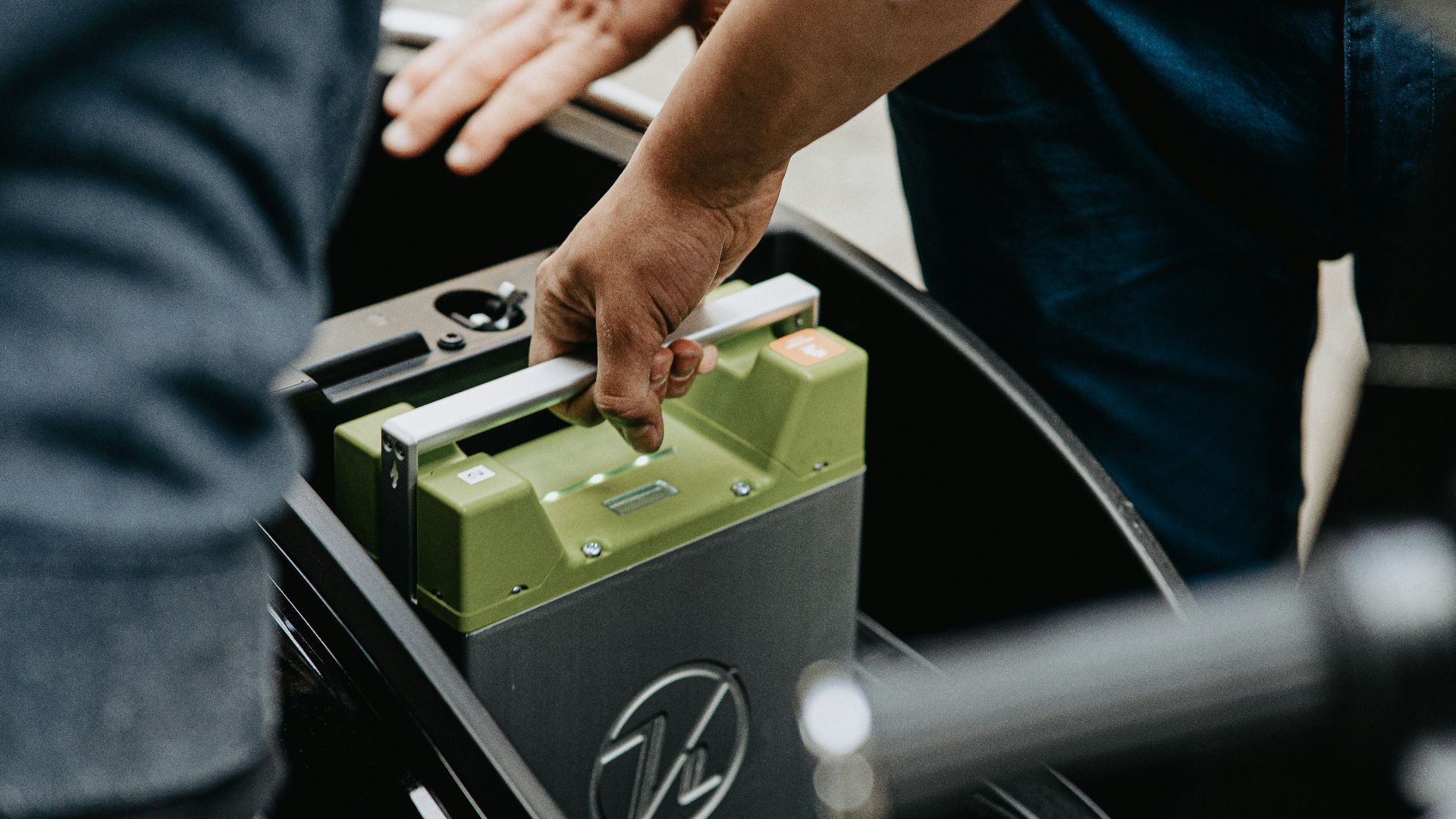person holding black and green electronic device