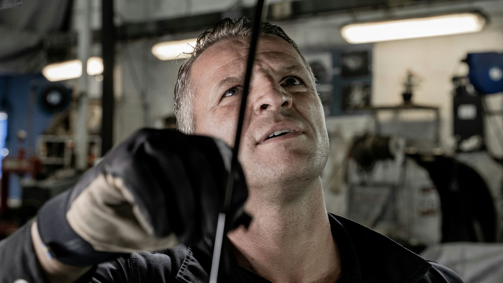 a man working on a car in a garage