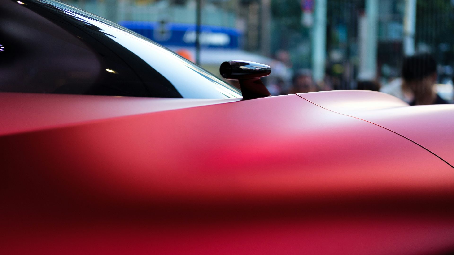 a red sports car parked on the side of the road