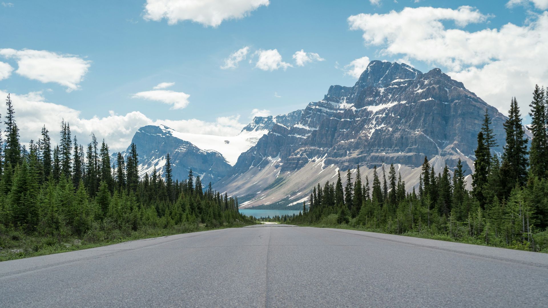 a road with a mountain in the background
