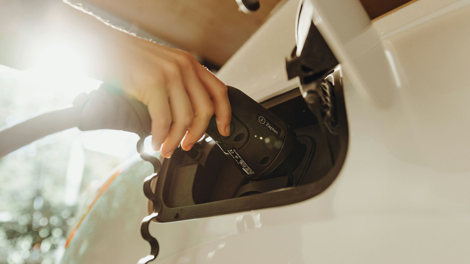 a person pumping gas into a car at a gas station