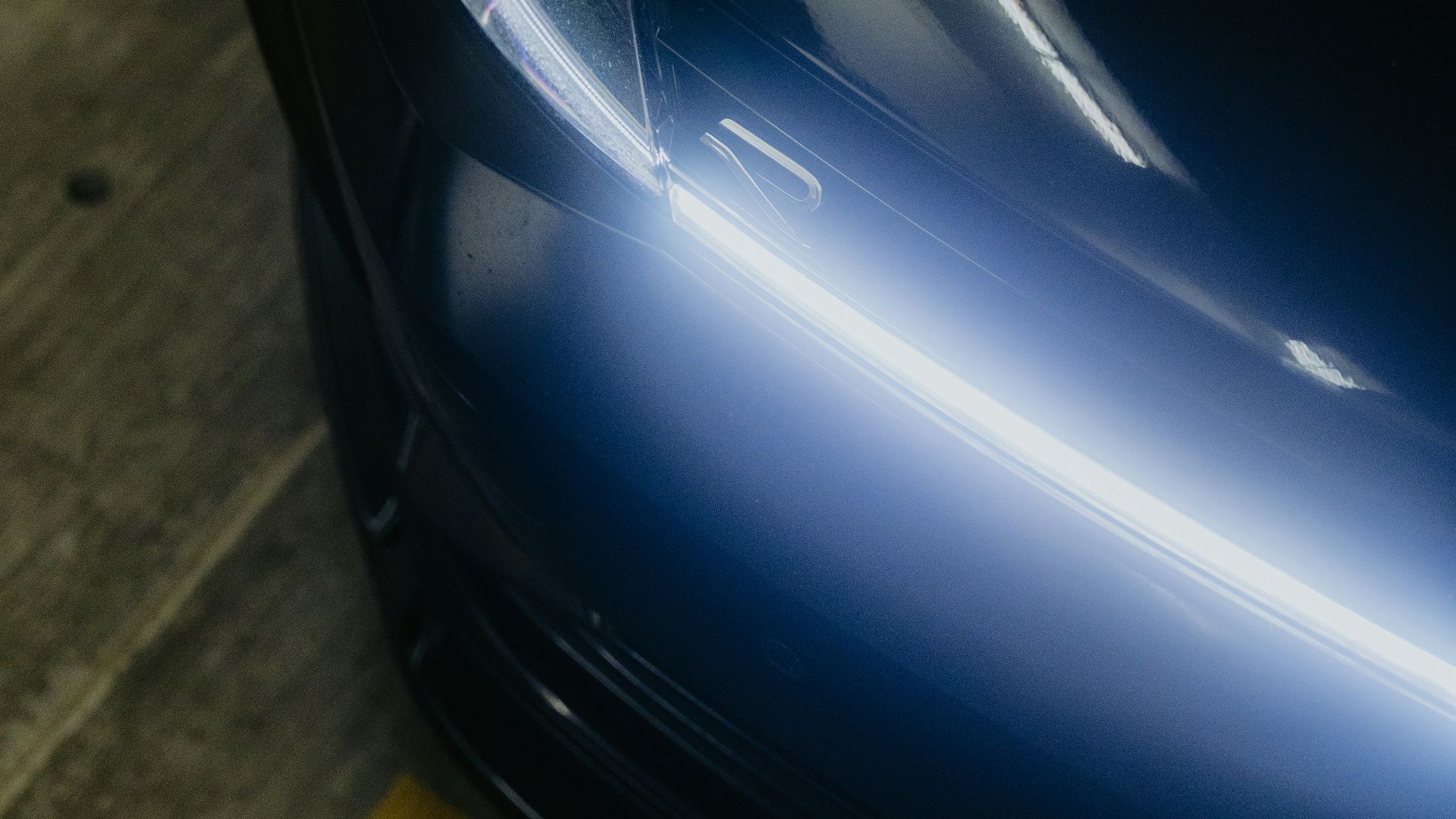 Close-up of a dark blue car headlight.