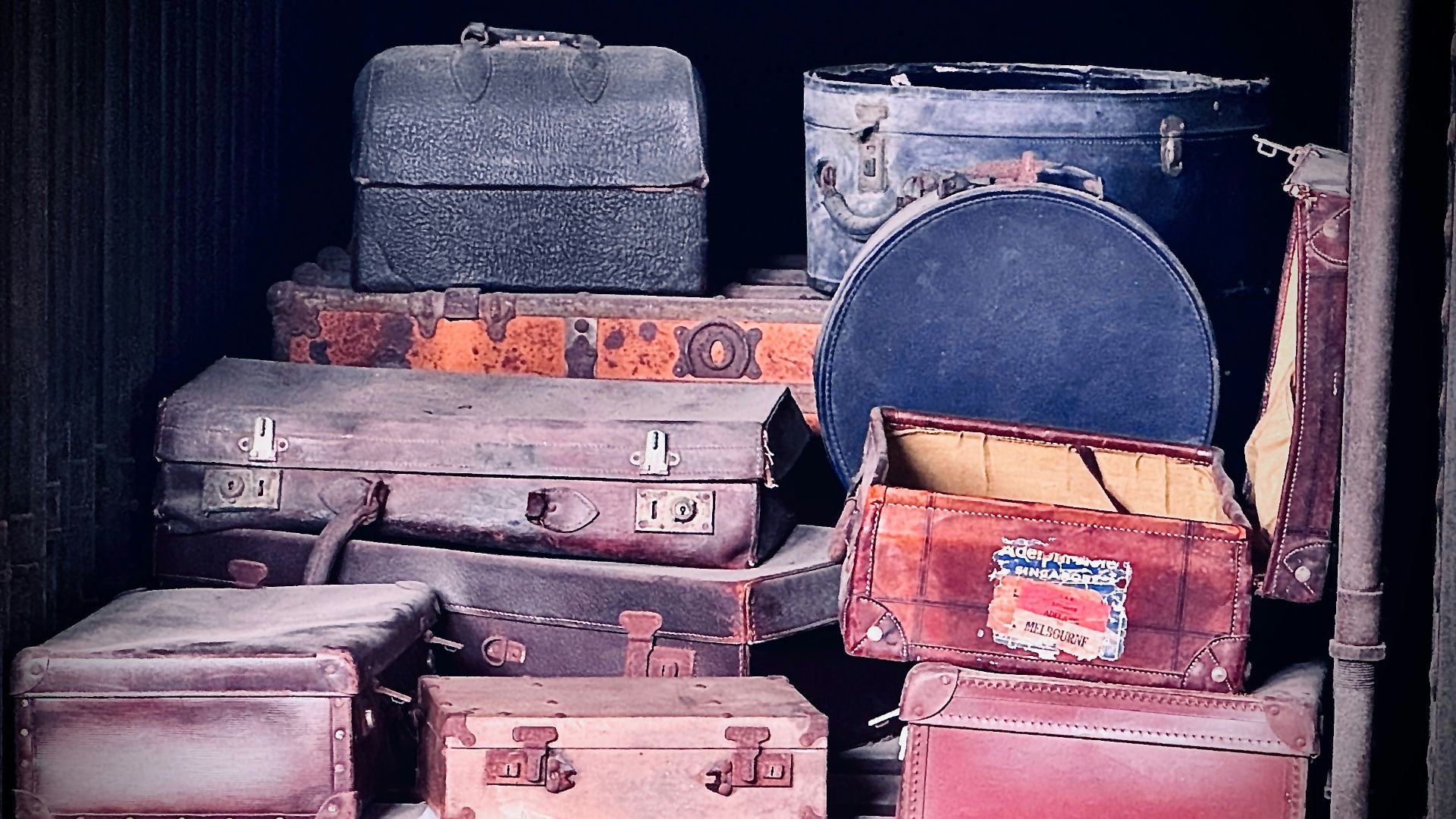 a pile of old suitcases sitting next to each other