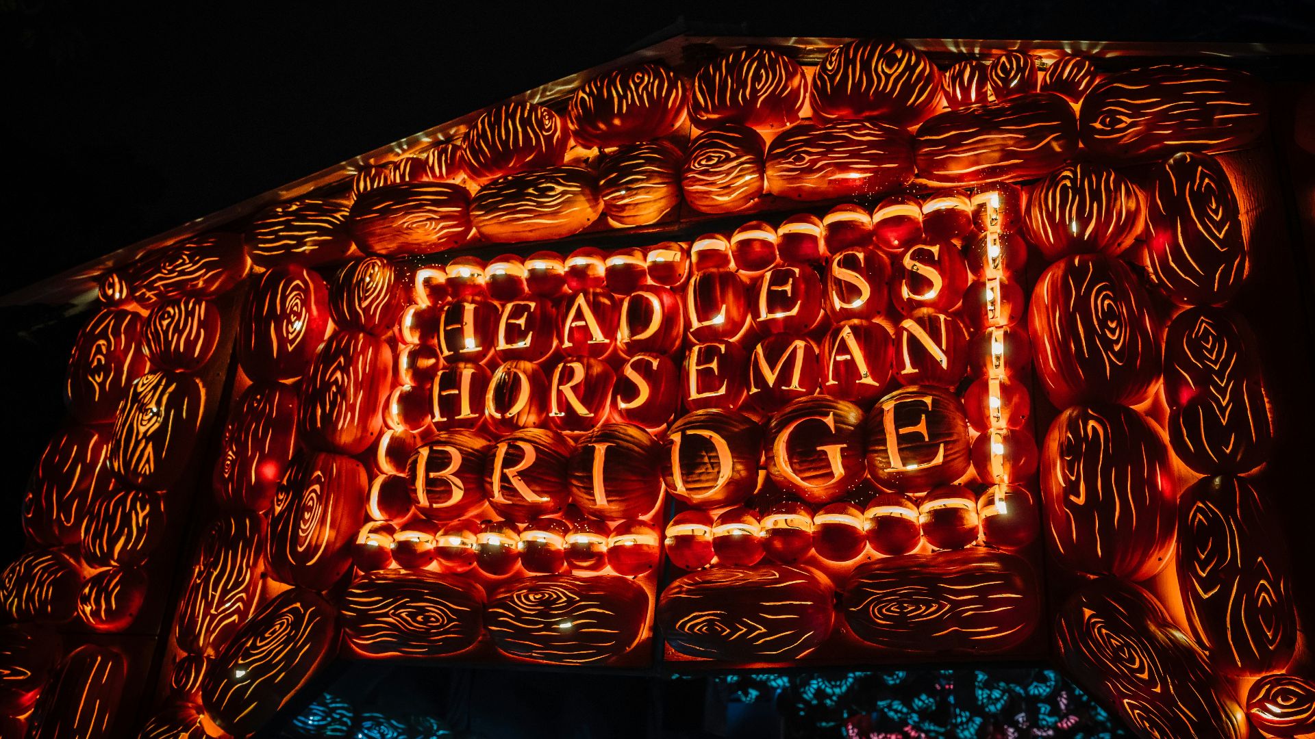 a lit up sign that says, headless horseman bridge