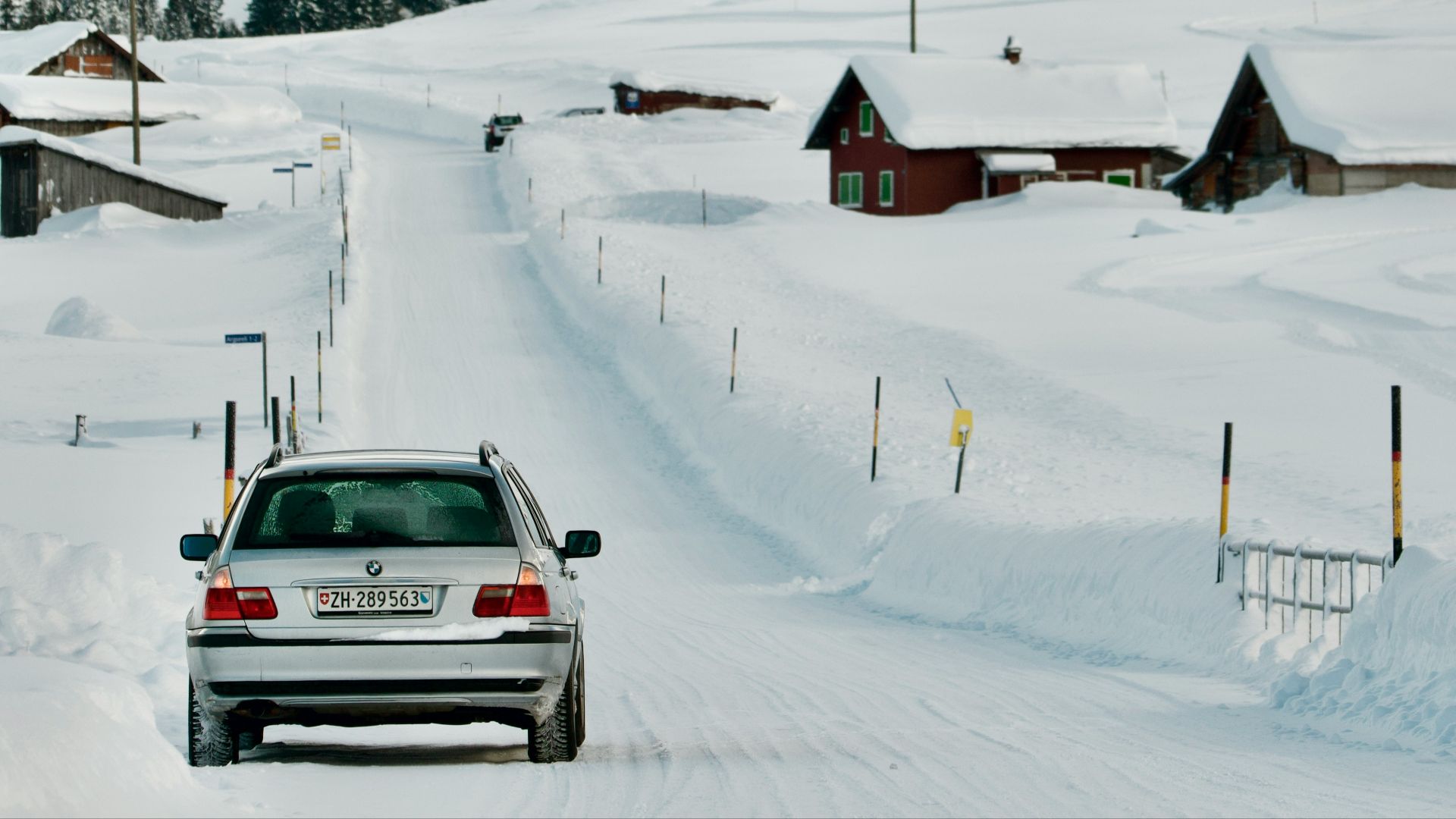a car driving down a snow covered road
