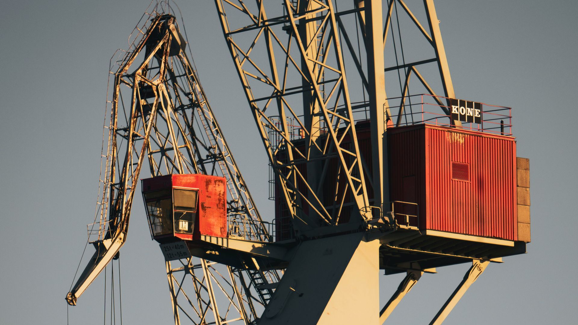 white and red crane under blue sky during daytime