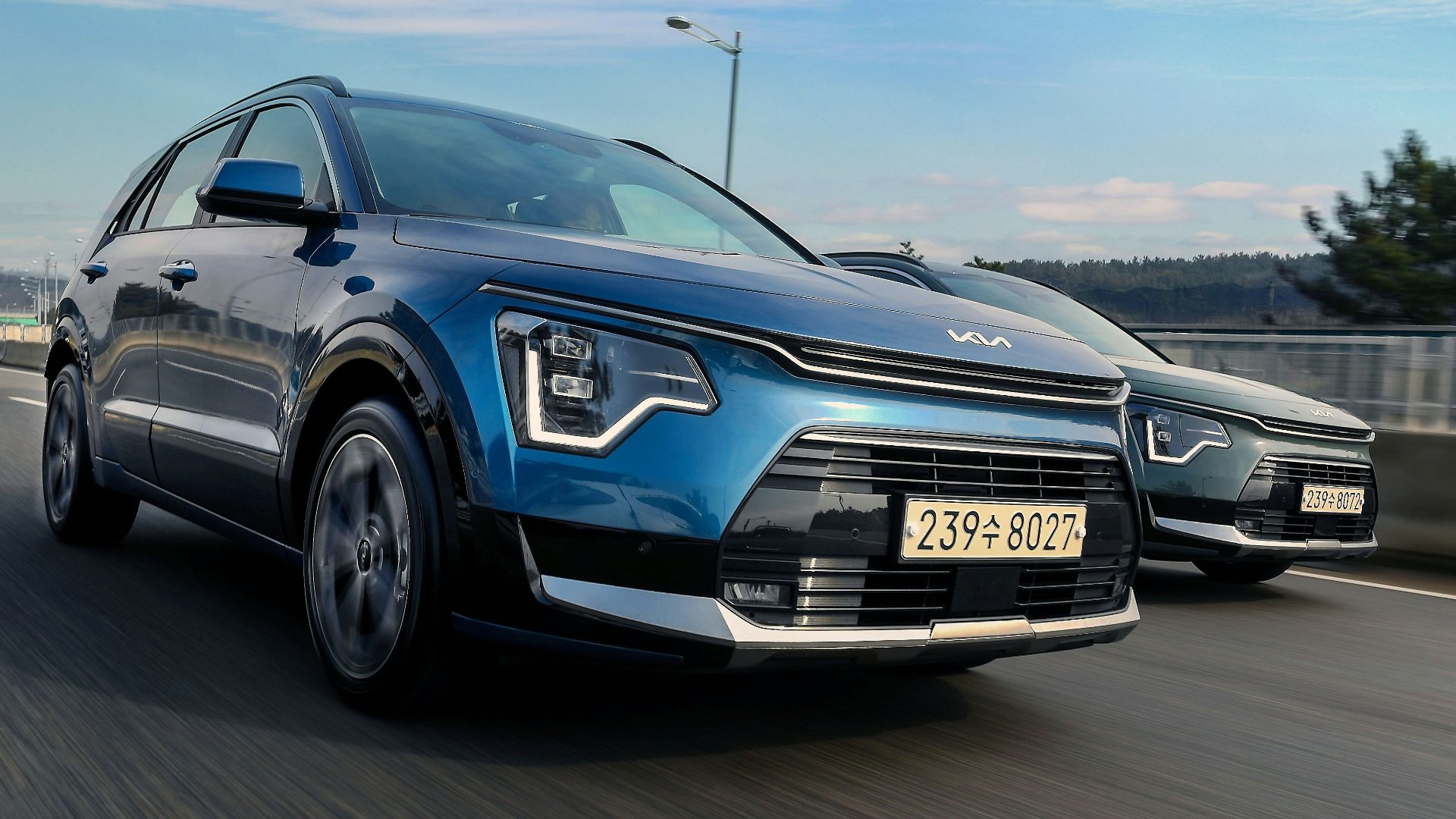 a couple of cars driving down a highway