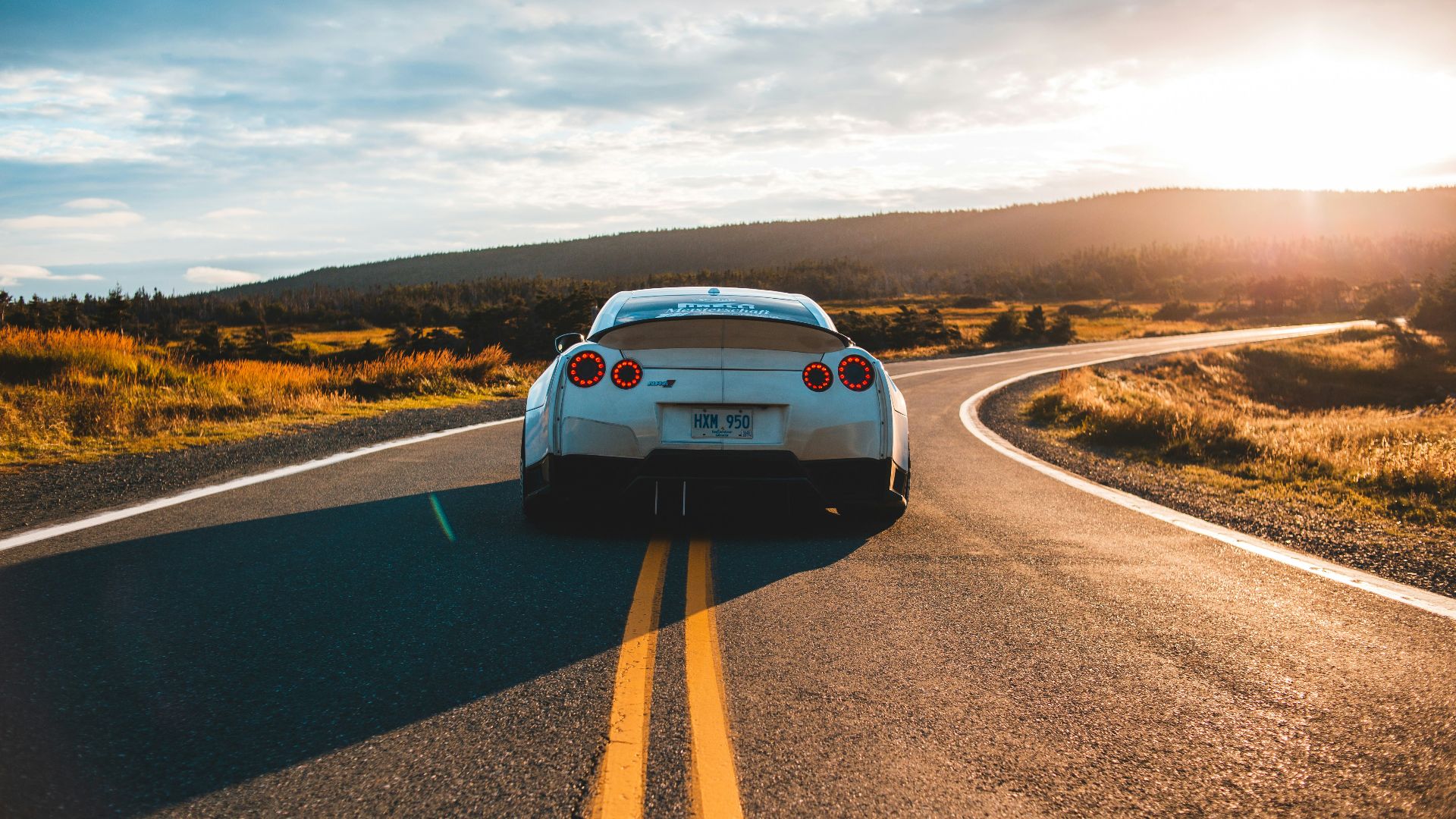 silver sports coupe on asphalt road