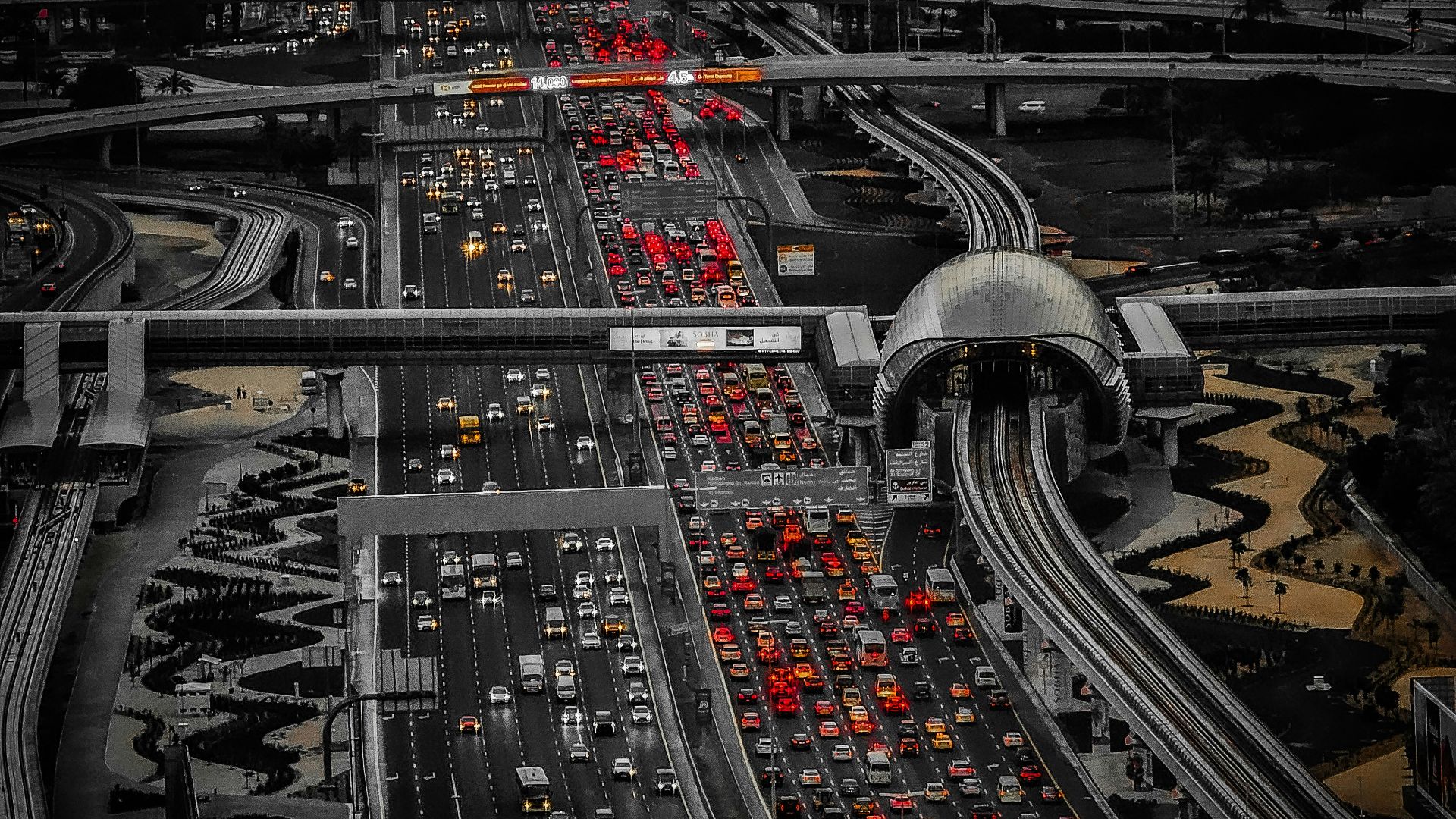 A highway filled with lots of traffic under a cloudy sky