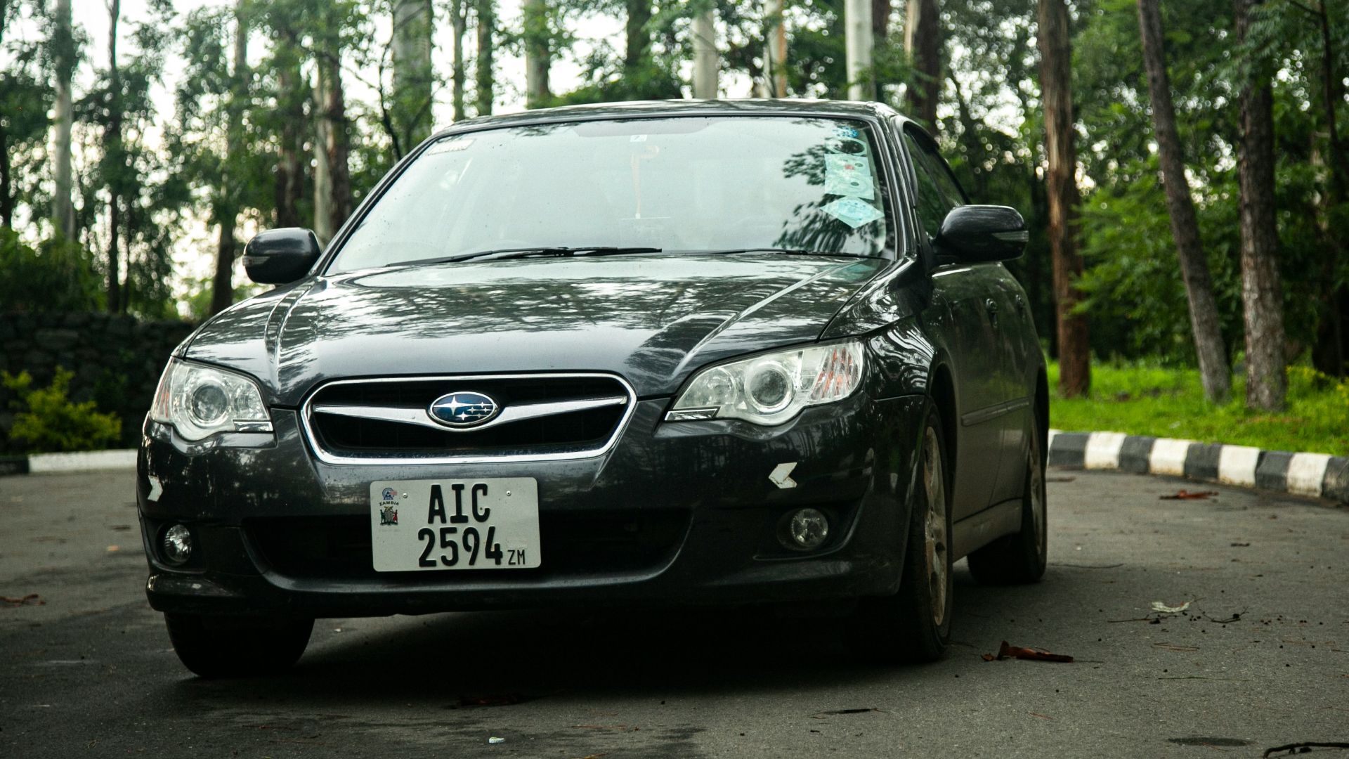 a black car parked on the side of the road