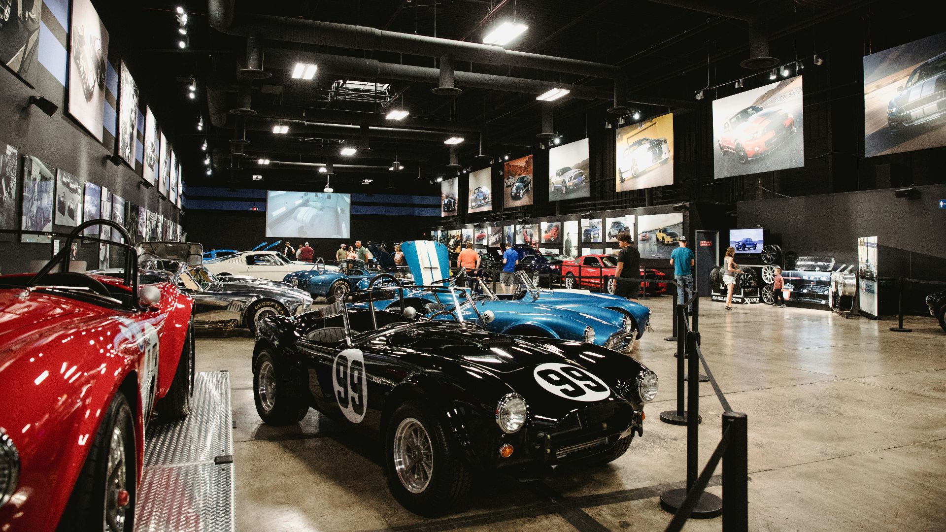different vehicles in a car show inside building